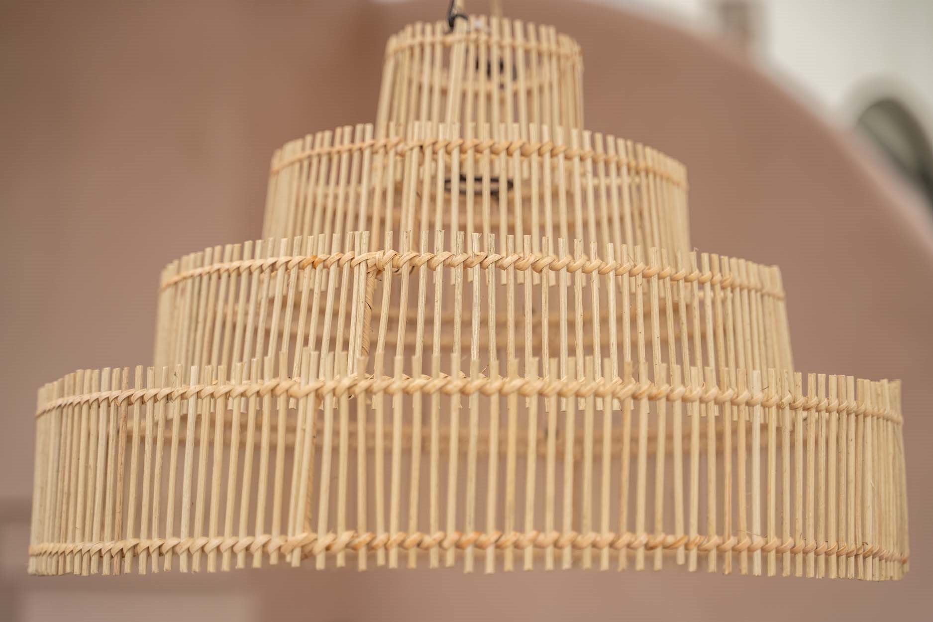 Medium rattan pendant light with tapered wedding cake design for soft, ambient interior glow