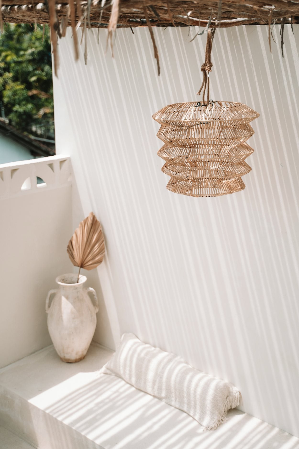 Medium rattan pendant light with tapered shape, perfect for adding flair to boho living spaces
