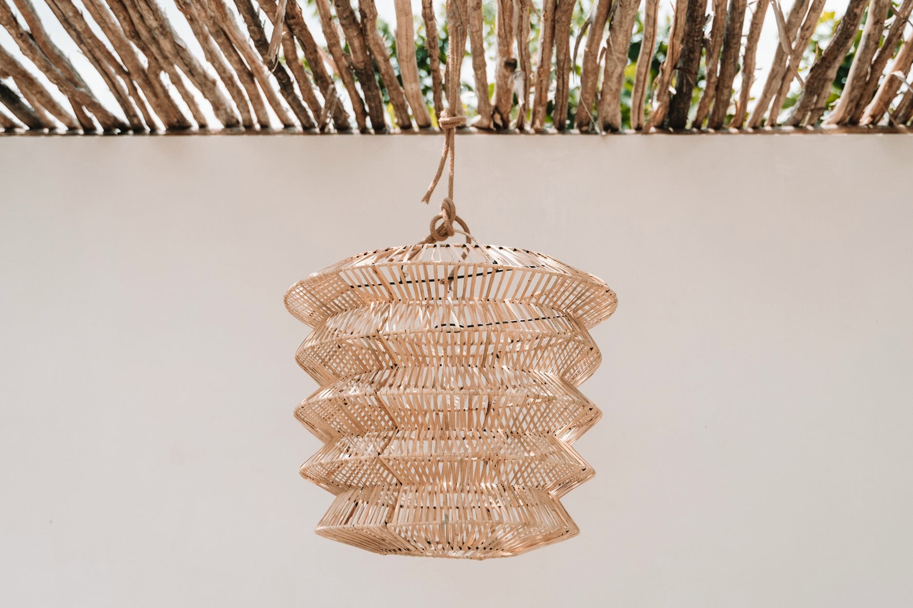 Natural rattan pendant light with unique form, ideal for soft lighting in modern interiors