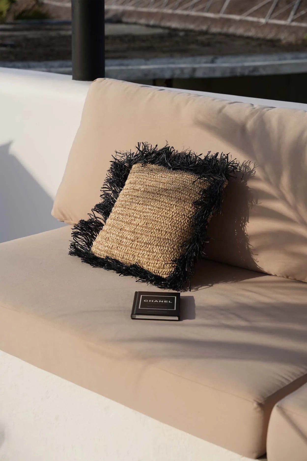 Natural black raffia cushion cover 40x40 with fringe details, perfect for any room.