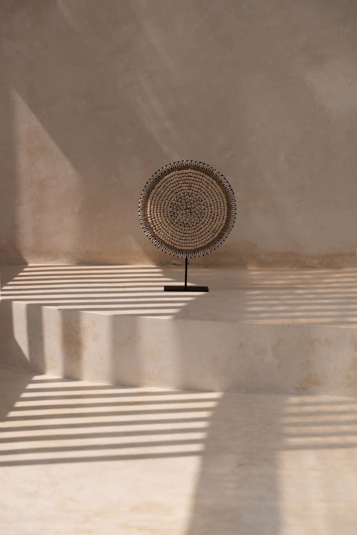 Handcrafted shell sculpture with sleek black stand – perfect for modern boho homes