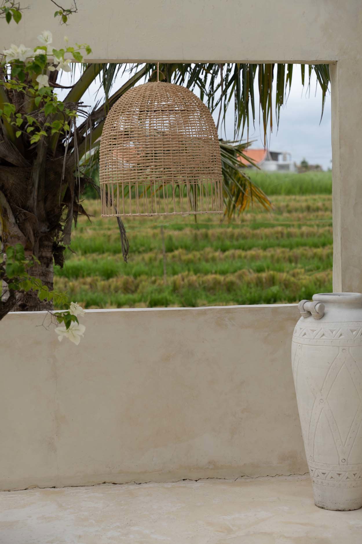 Handmade pendant light in rattan with open weave design, ideal for cozy and airy living spaces