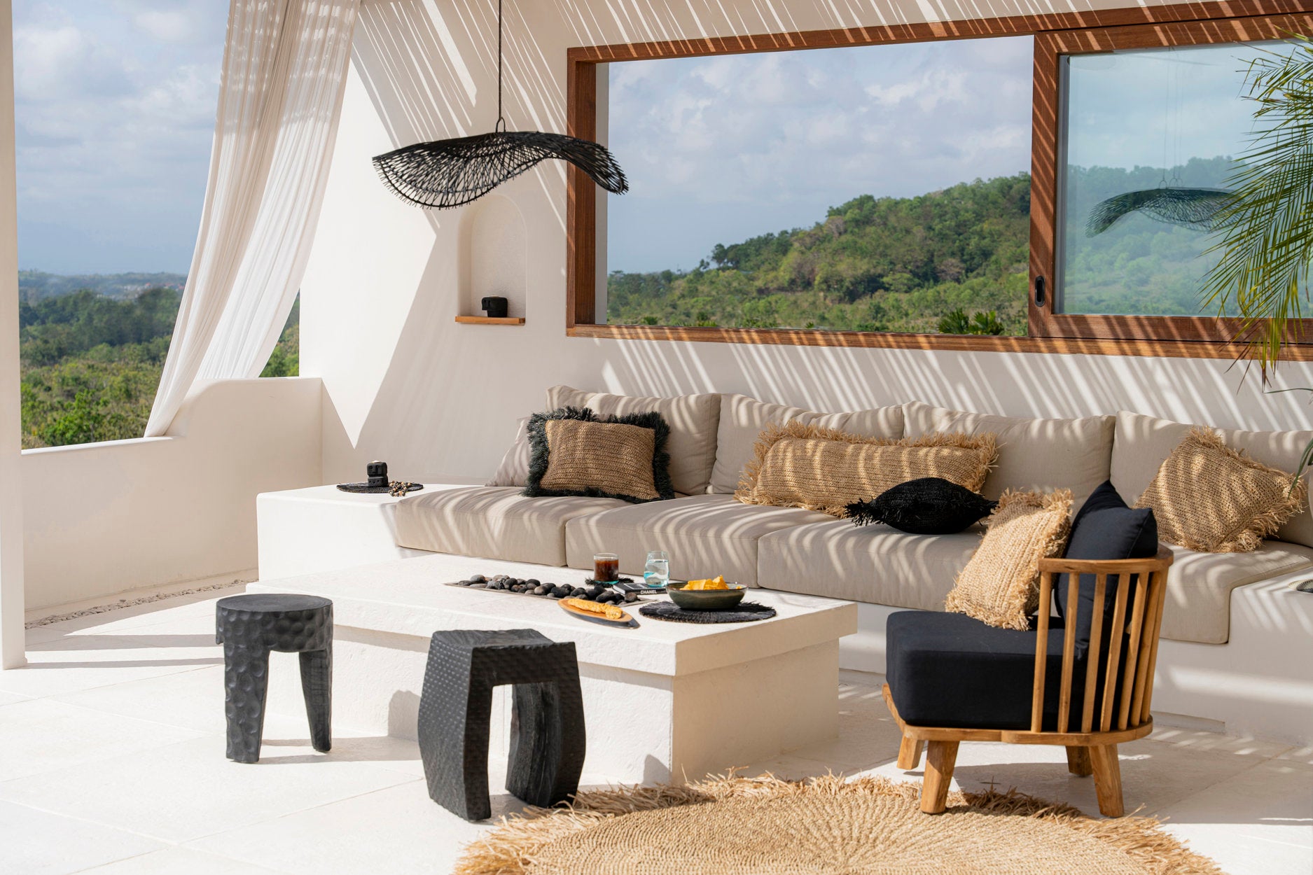 Black boho pendant light with woven rattan texture, ideal for living rooms or relaxed corners