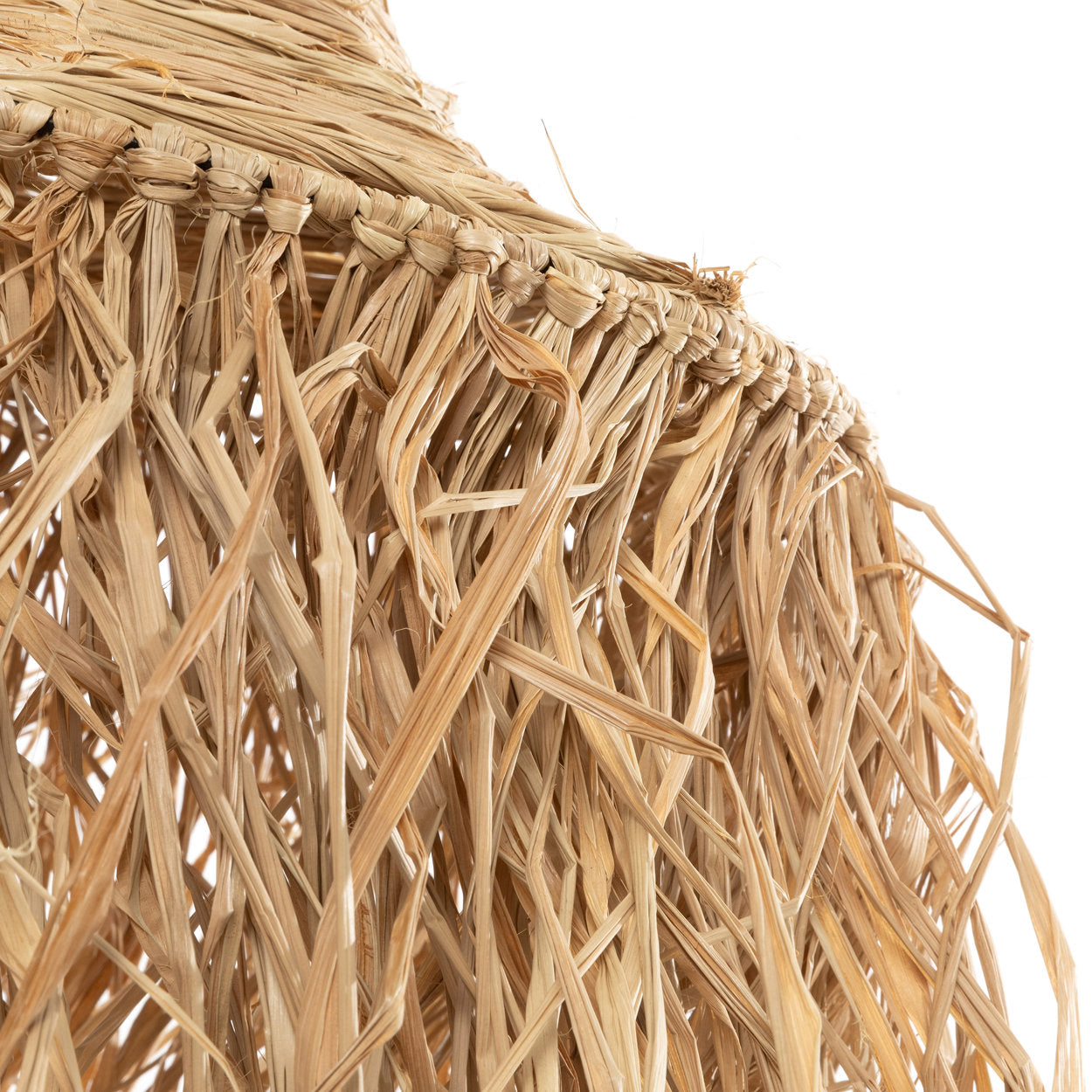 Natural pendant light in tropical style, casting soft shadows in coastal and boho interiors