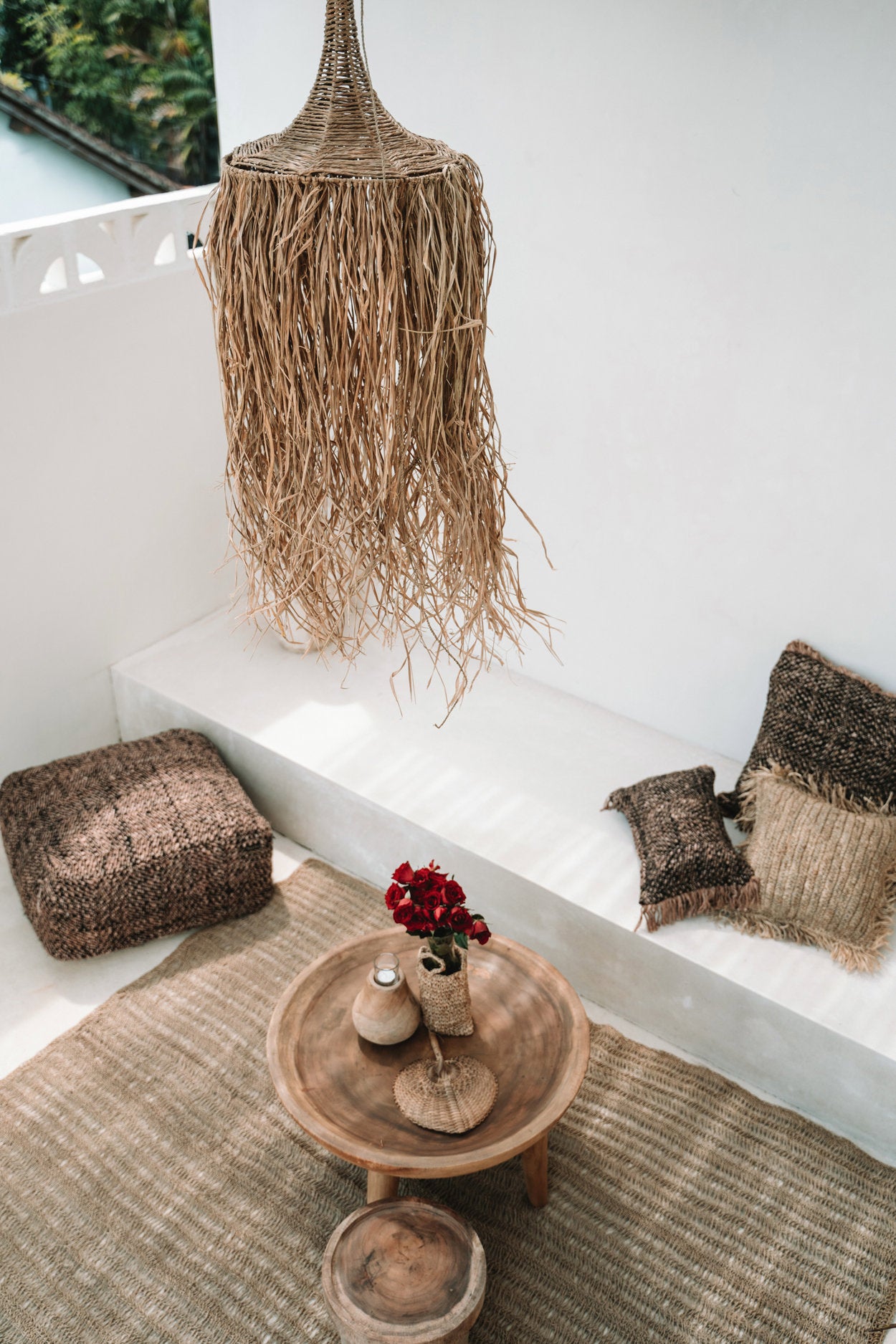 Tropical pendant light crafted from raffia and rattan, bringing coastal charm to any space