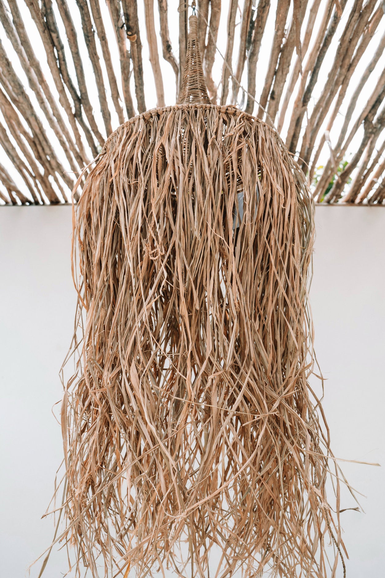 Long natural pendant light with beach club vibe, perfect for relaxed outdoor or indoor use