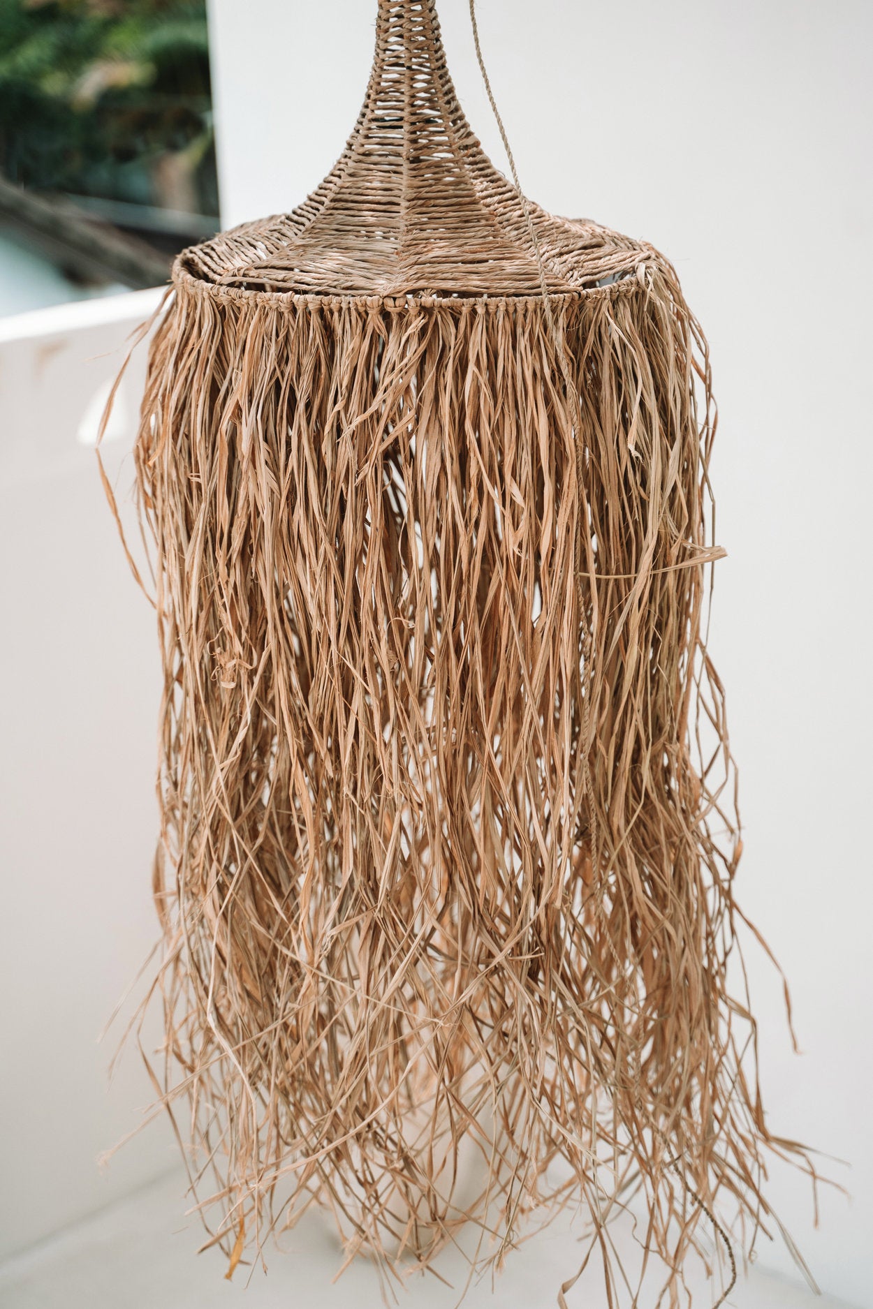 Raffia and rattan pendant light in natural tone, ideal for covered patios or beach-style rooms
