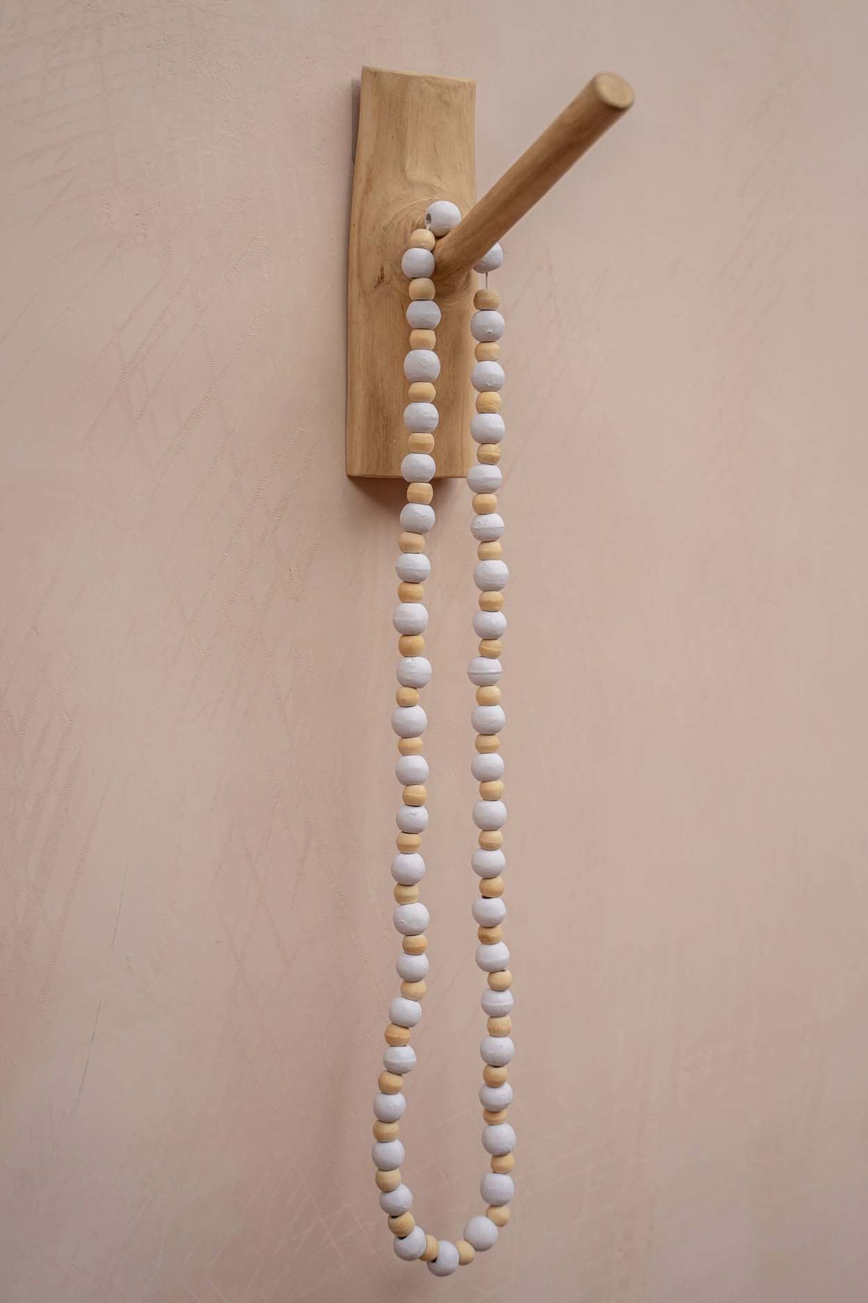 Minimalist solid wood coat hook with organic grain texture