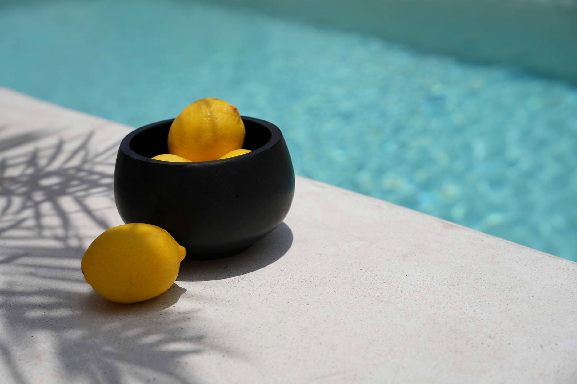 Handmade teak black serving bowl, blending durability and elegance for modern or rustic dining spaces.