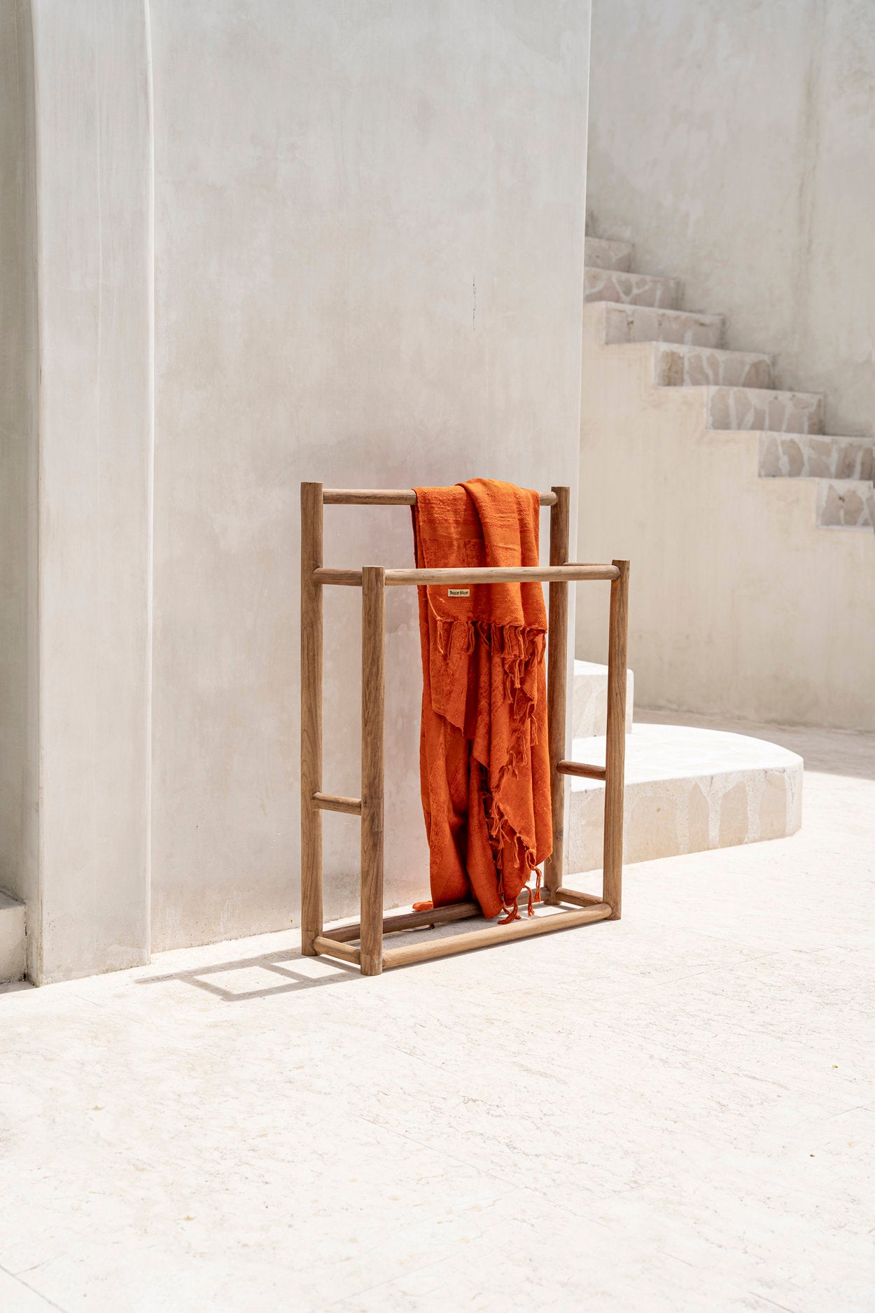 Boho-style wooden towel hanger with warm rustic tones