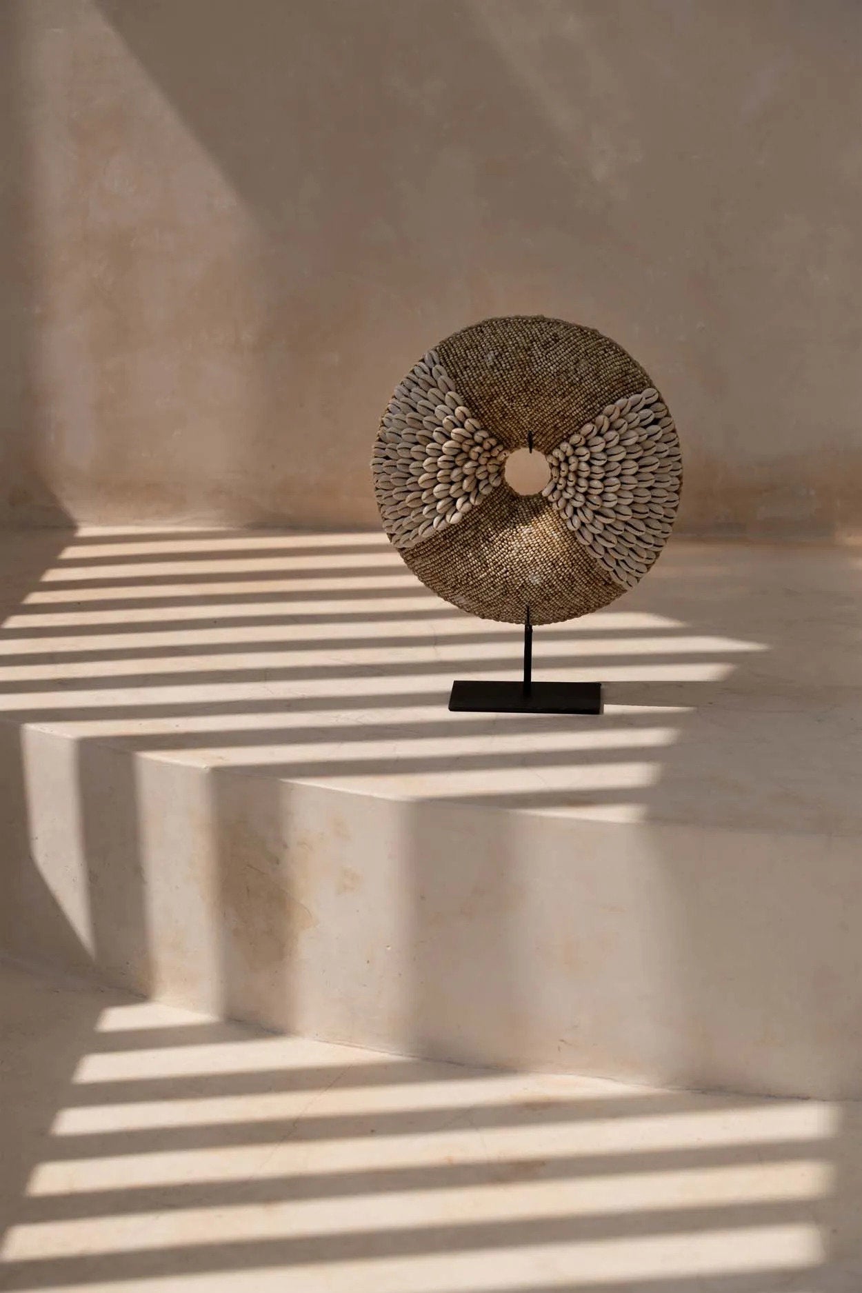 White shell display stand with playful circular design