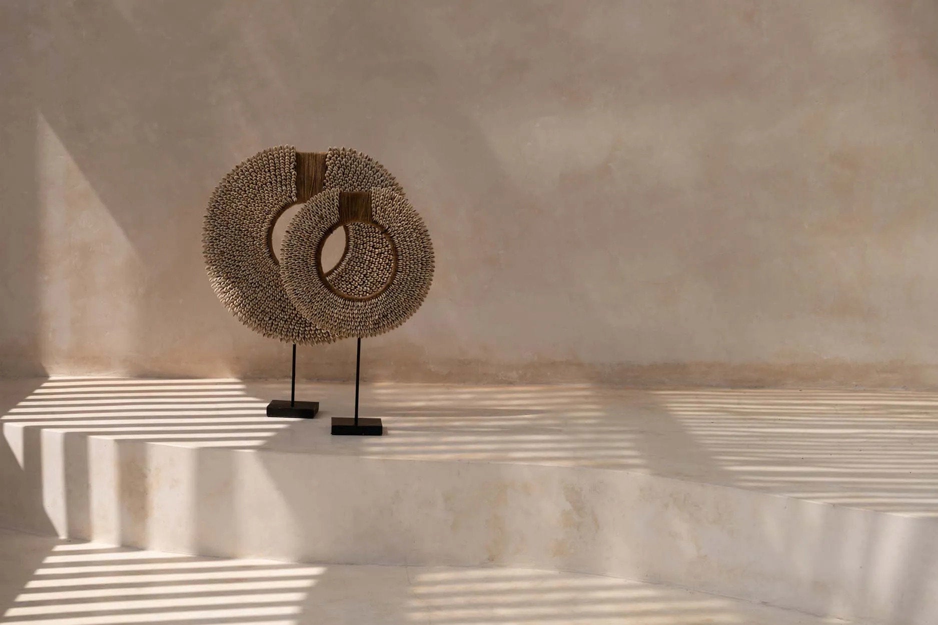 Boho shell stand display with artistic curves and beach-inspired charm.