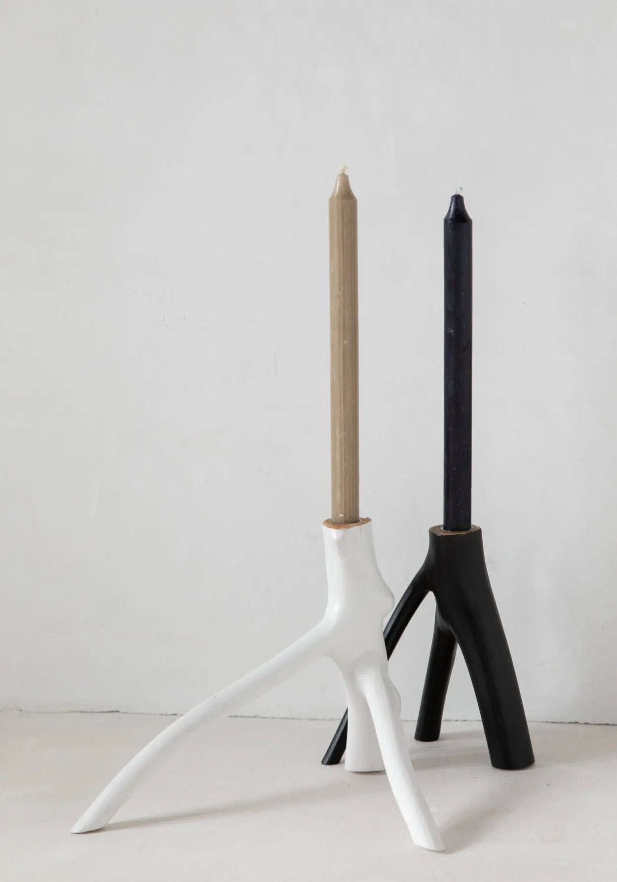 Minimalist white candle stand with bold, organic shape