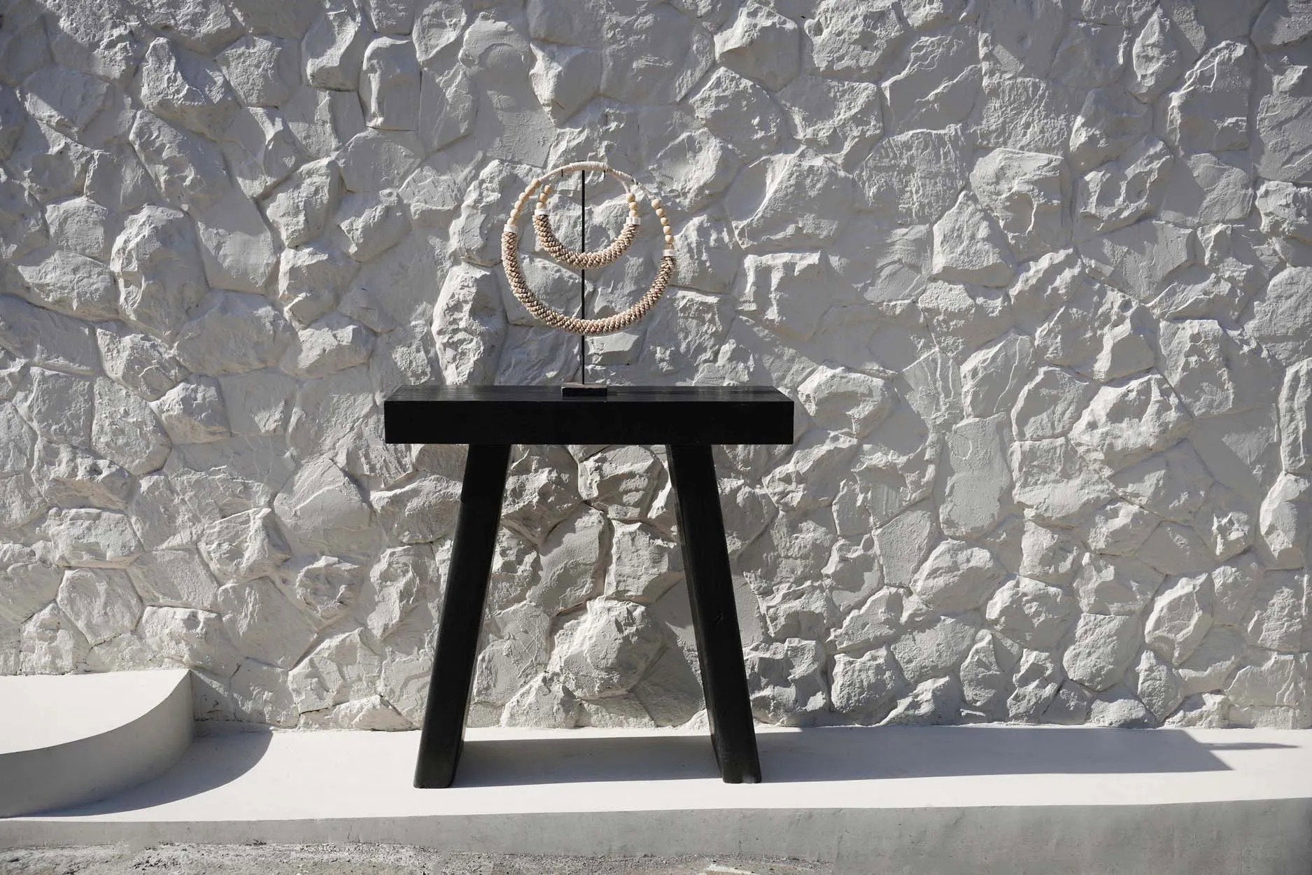 Coastal-style shell necklace stand for entry table