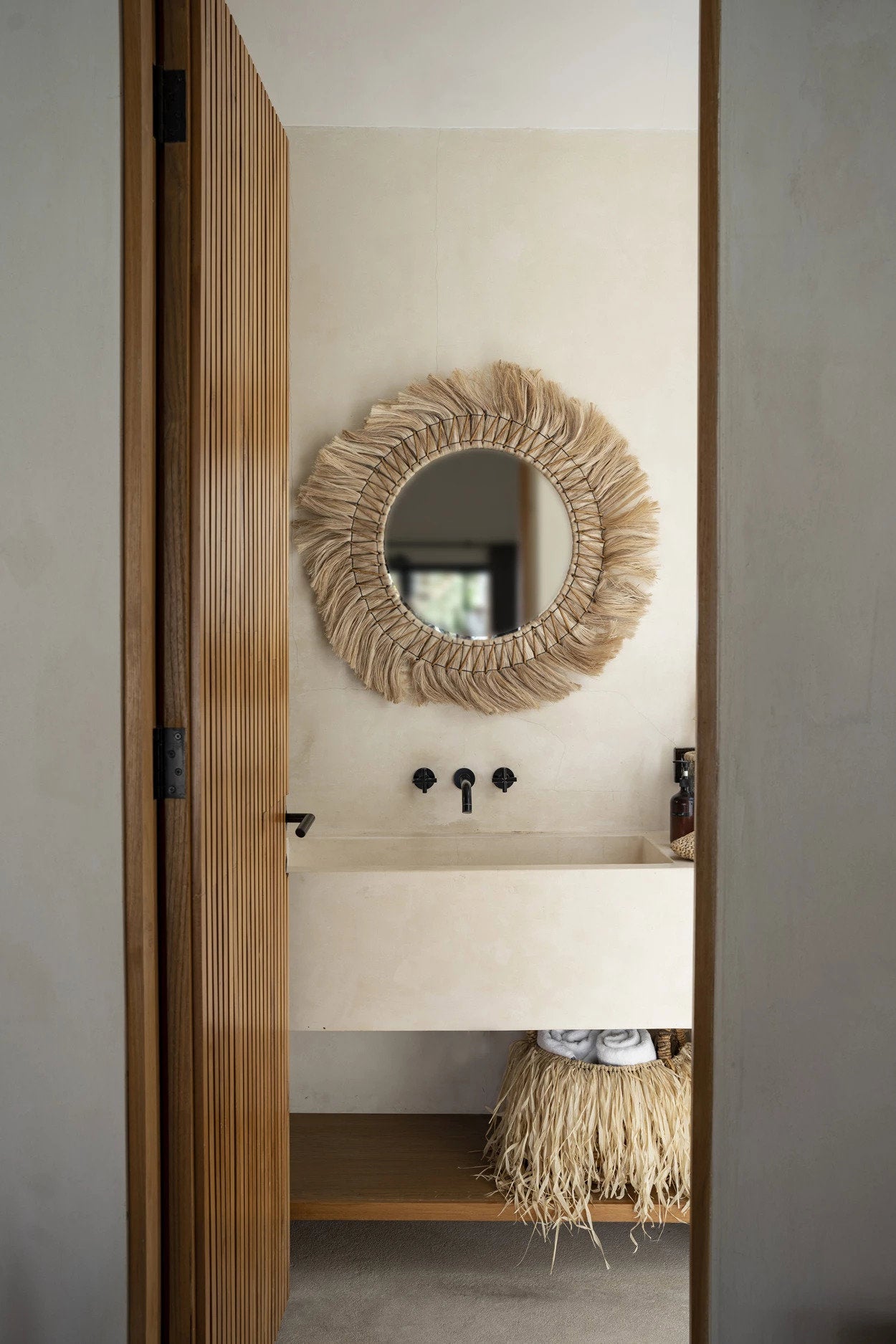 Large bohemian mirror made from sustainable natural materials, perfect above a vanity or console table.