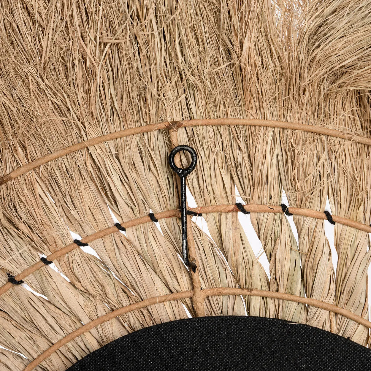 Stylish grass framed mirror reflecting light beautifully, adding warmth and character to any home décor.