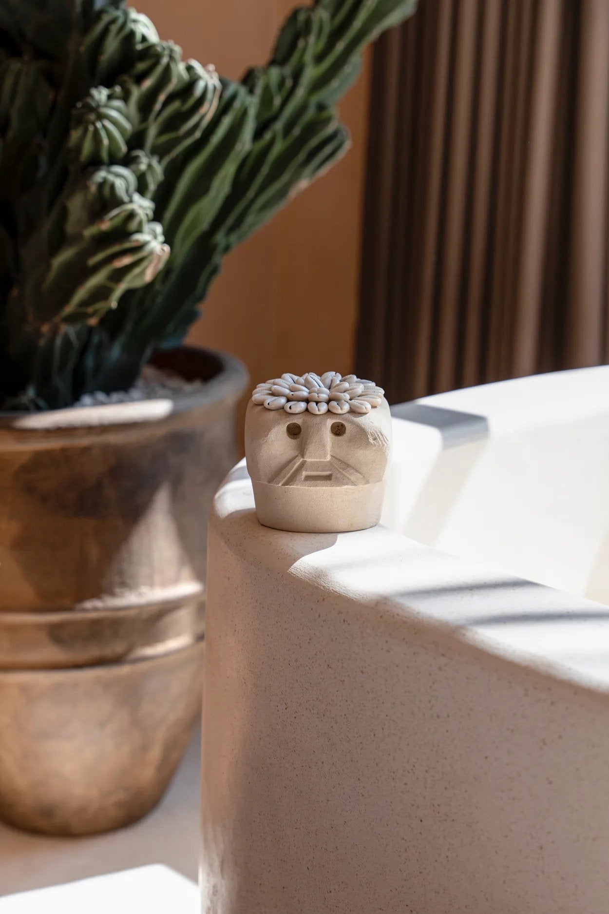 Ethnic sandstone statue in natural finish, ideal as a unique accent piece for shelves, side tables, or mantels.