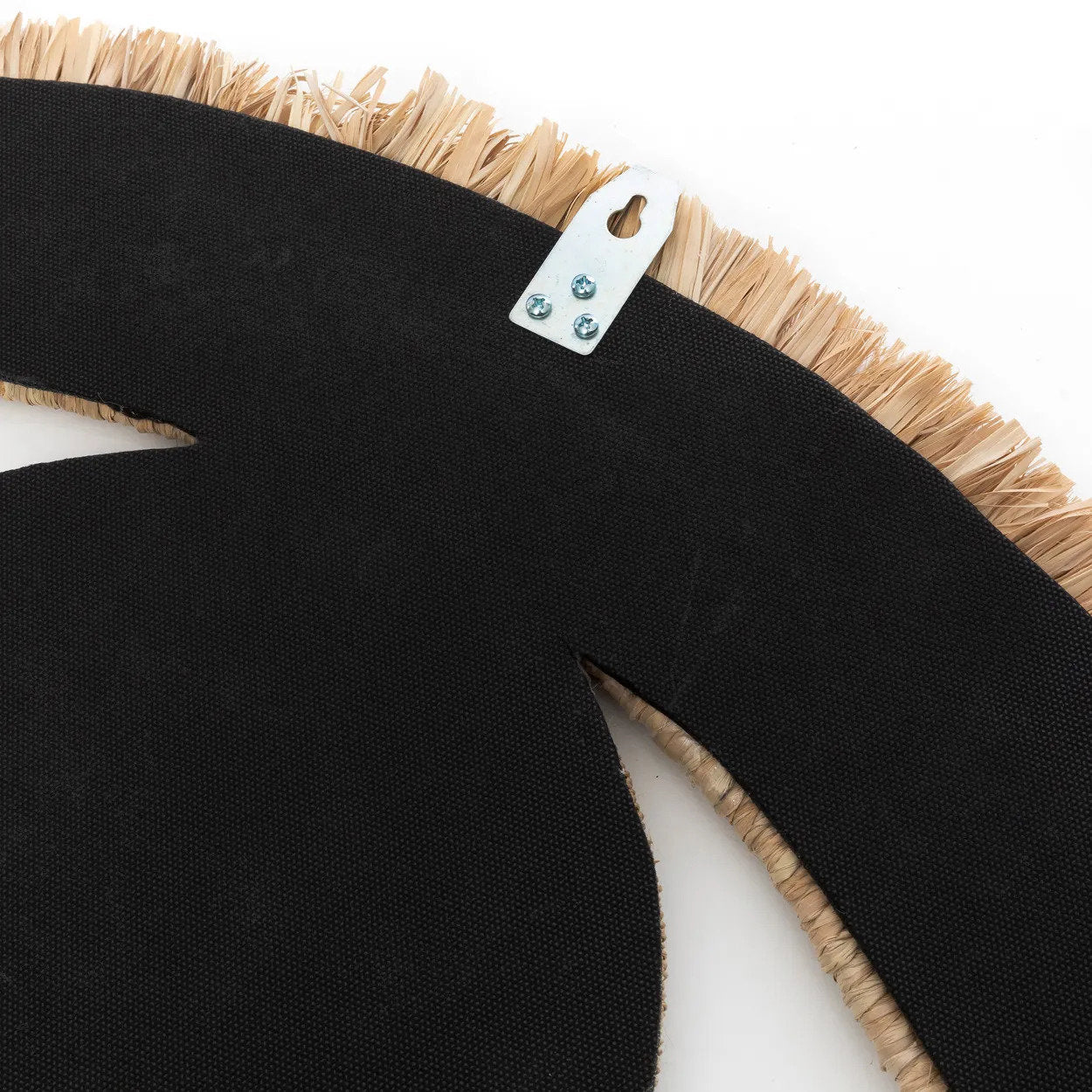 The Raffia Eye Mirror - Natural - M styled in a living room, adding a unique focal point to bohemian or coastal décor.