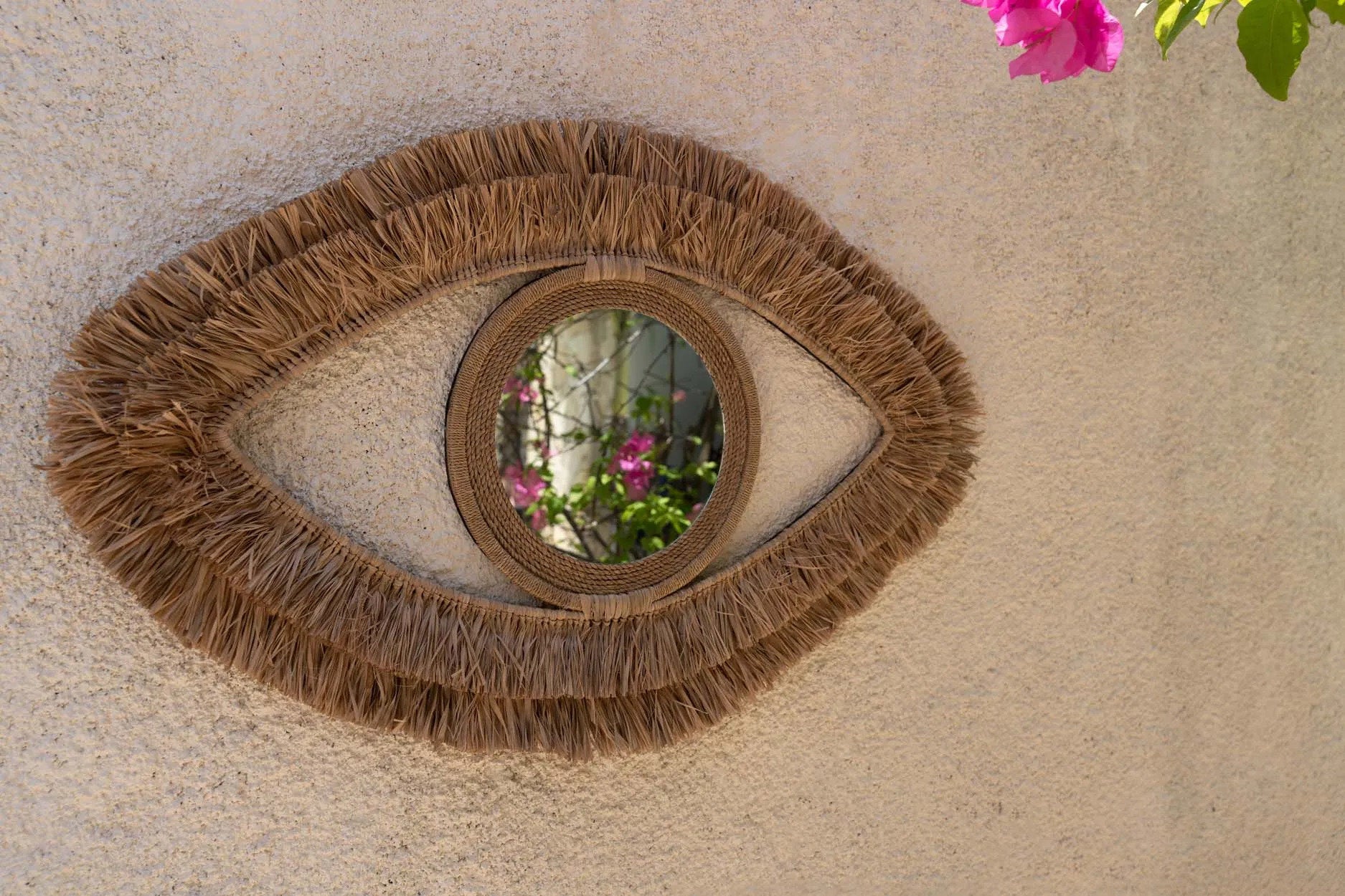 Close-up of the Raffia Eye Mirror - Natural - M showing intricate woven raffia details and artisanal craftsmanship.