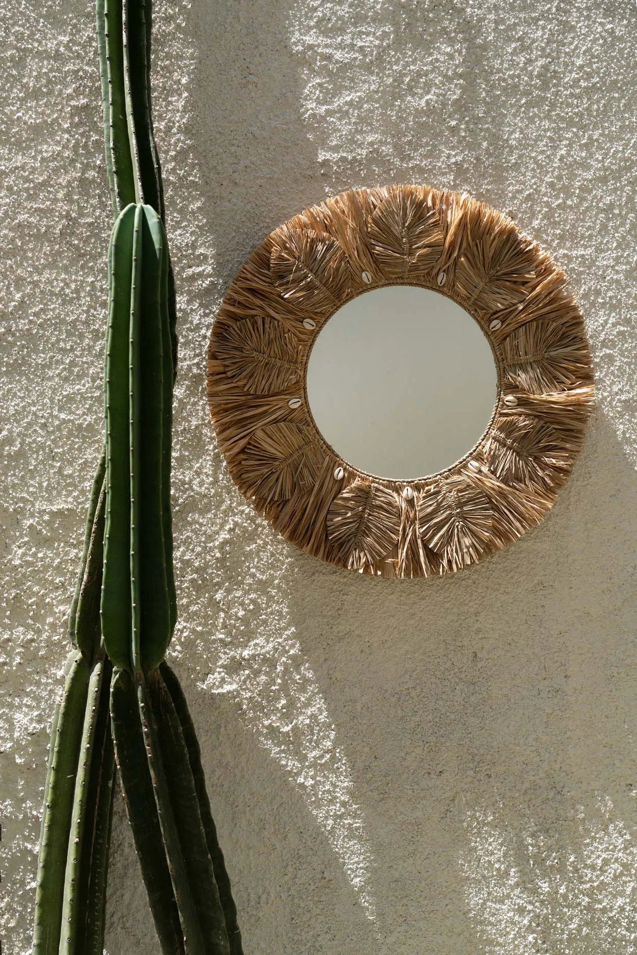 Medium-sized boho wall mirror shaped like palm leaves, ideal for living rooms, bedrooms, or entryways.