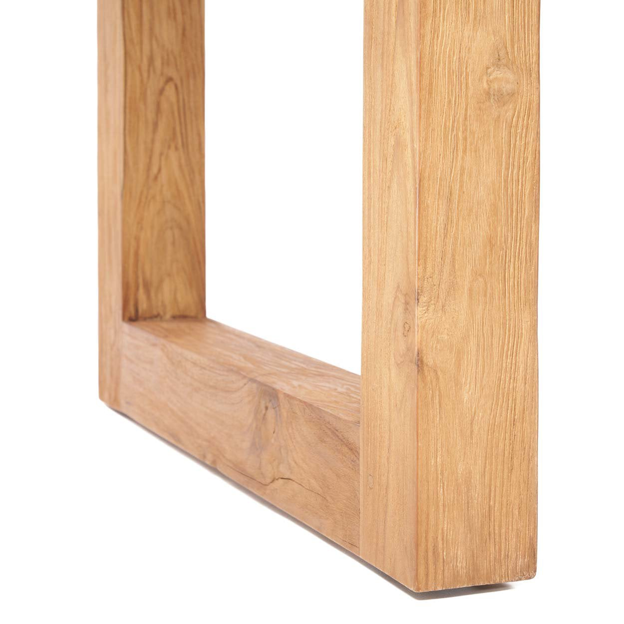 A spacious teak table with soft wood grain, made for open and airy exterior layouts.