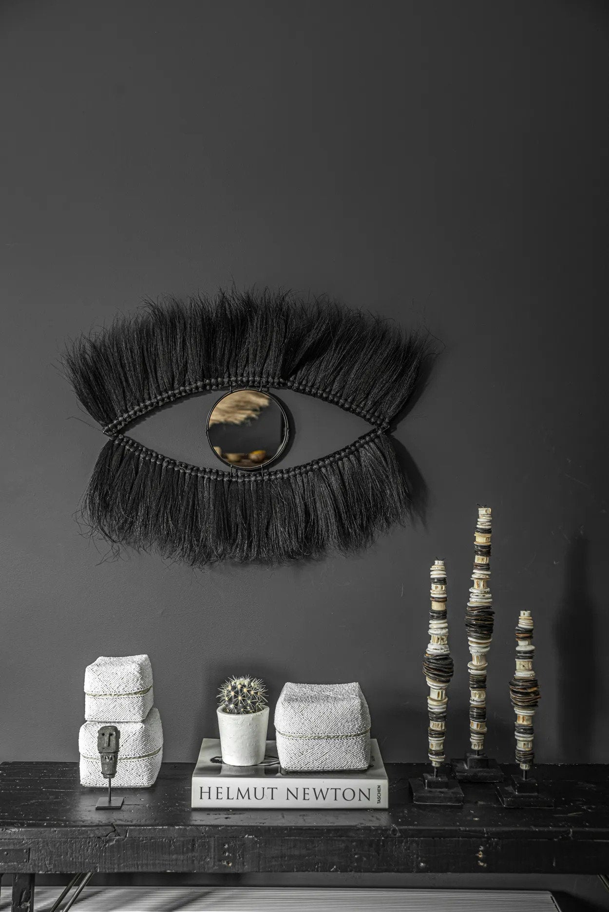 Close-up of the Black Eye Mirror - Black showing intricate handcrafted details and artisanal grass texture.