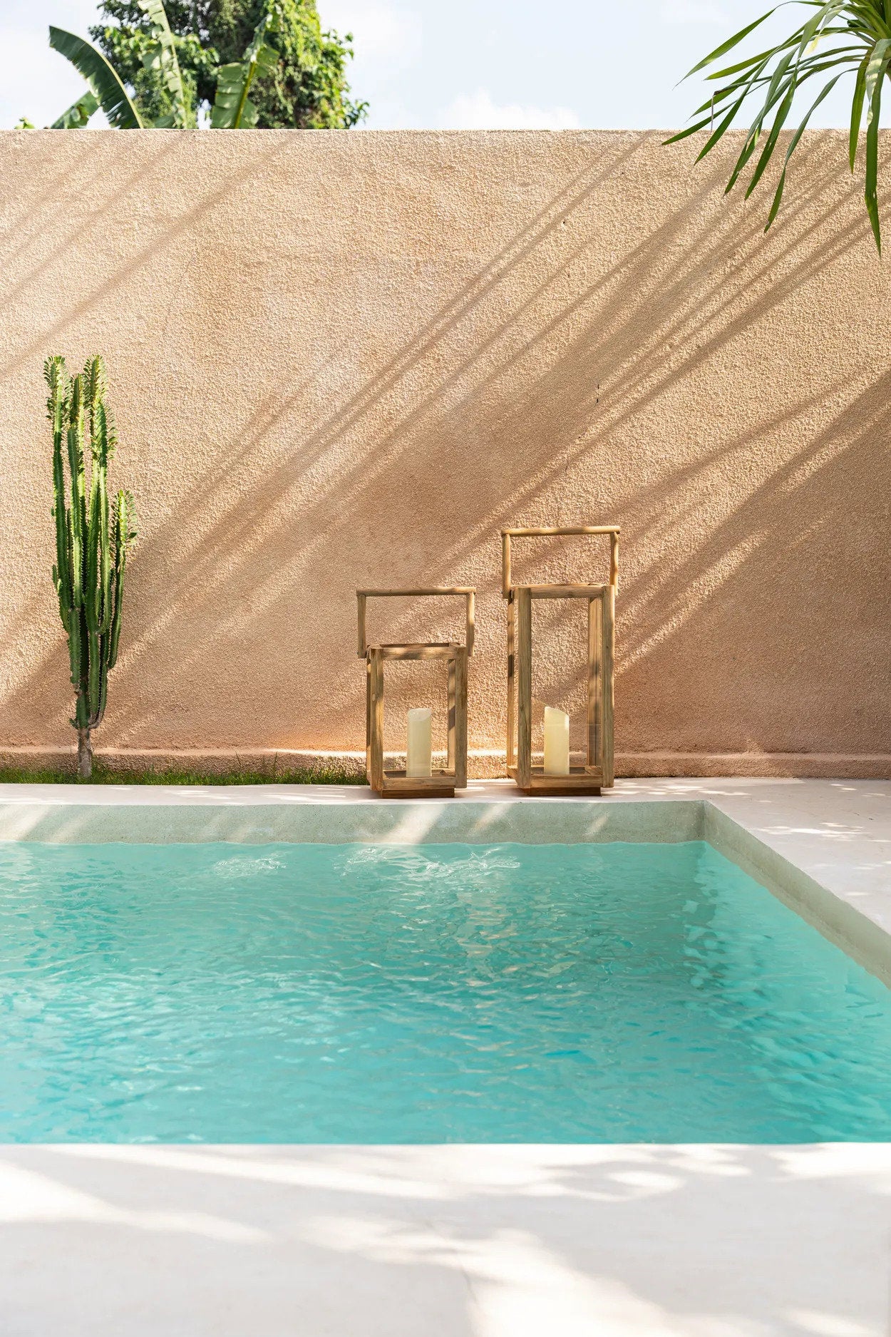 Tall teak wood lantern with glass sides for rustic patio or garden decor