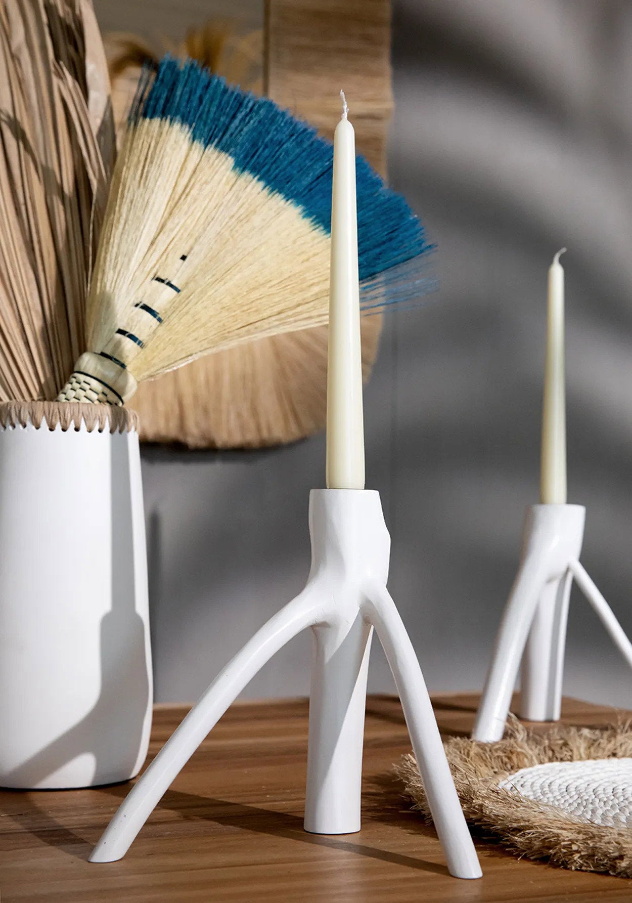 Sculptural white candle holder shaped like twisted tree branches