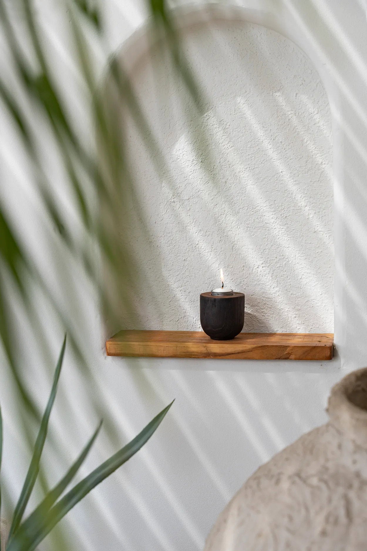 Teak wood tealight candle holder in a sleek black finish