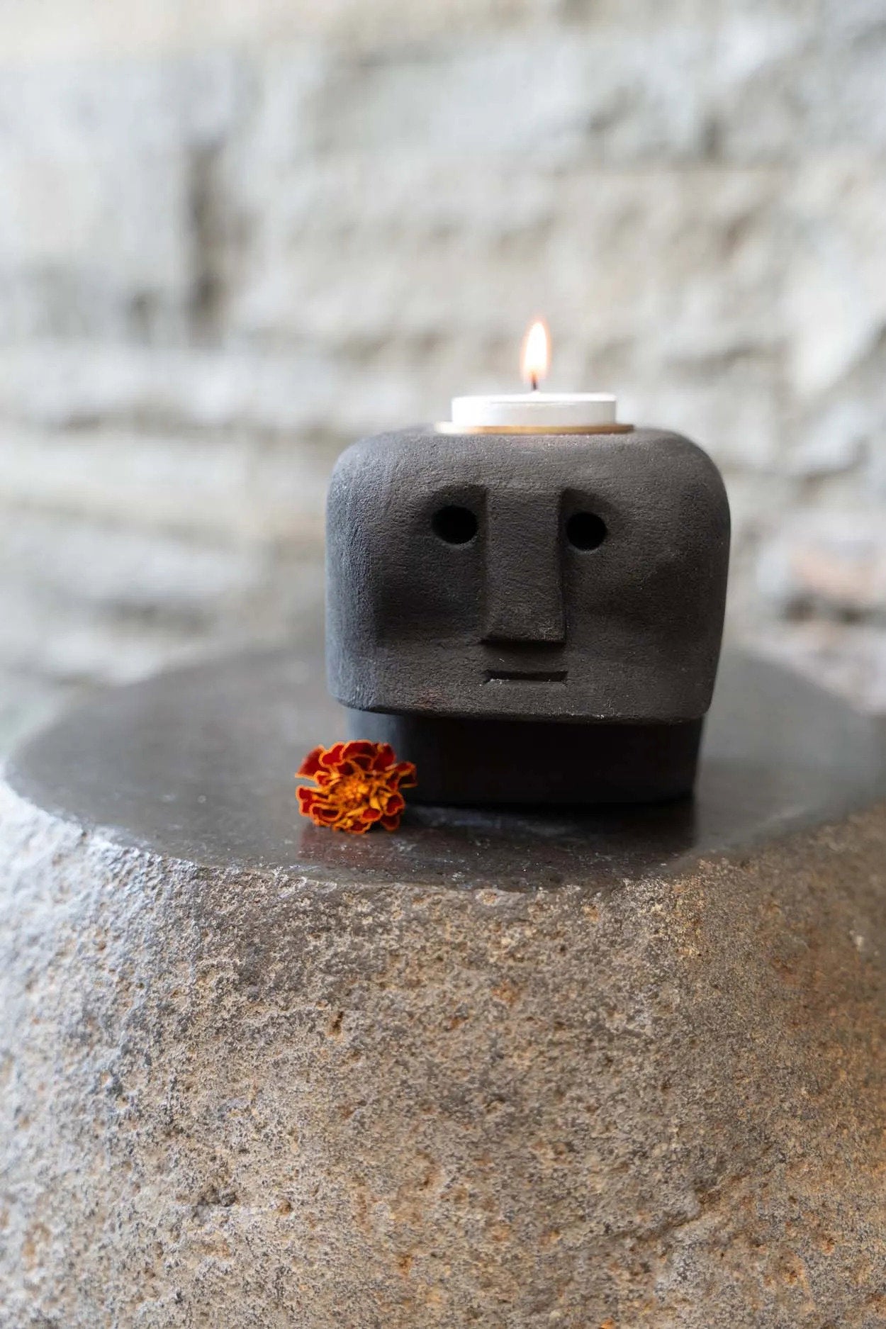 Decorative black stone candle holder inspired by Sumba tribal art