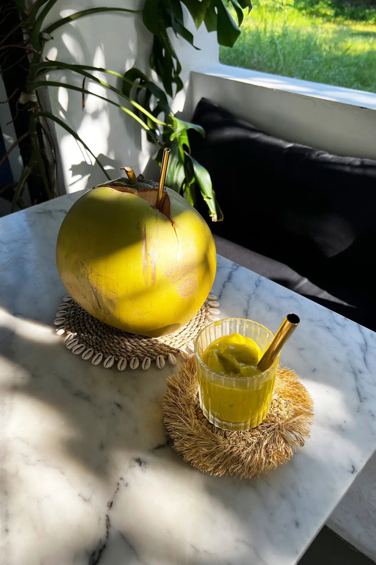 Artisan-made fringed raffia coaster, perfect for casual or formal table arrangements.