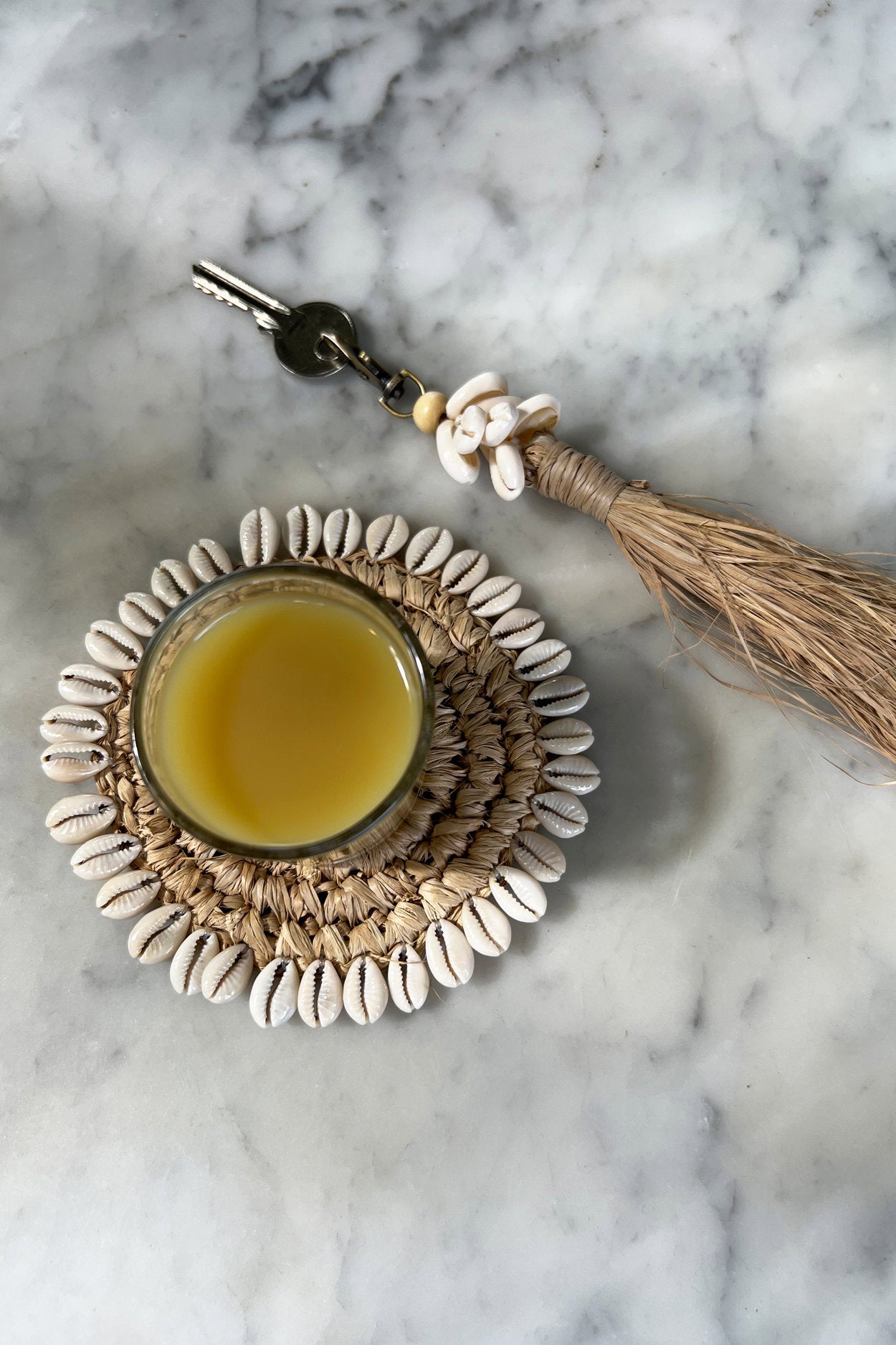the-raffia-cowrie-shell-keychain