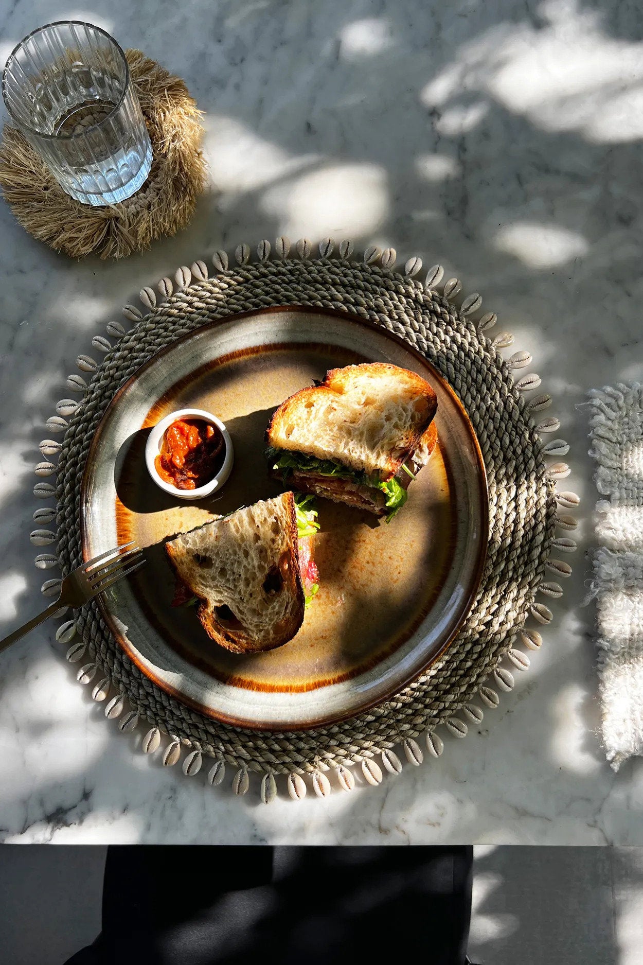 Durable seagrass shell placemat, lightweight yet sturdy, combining function with natural, earthy elegance.