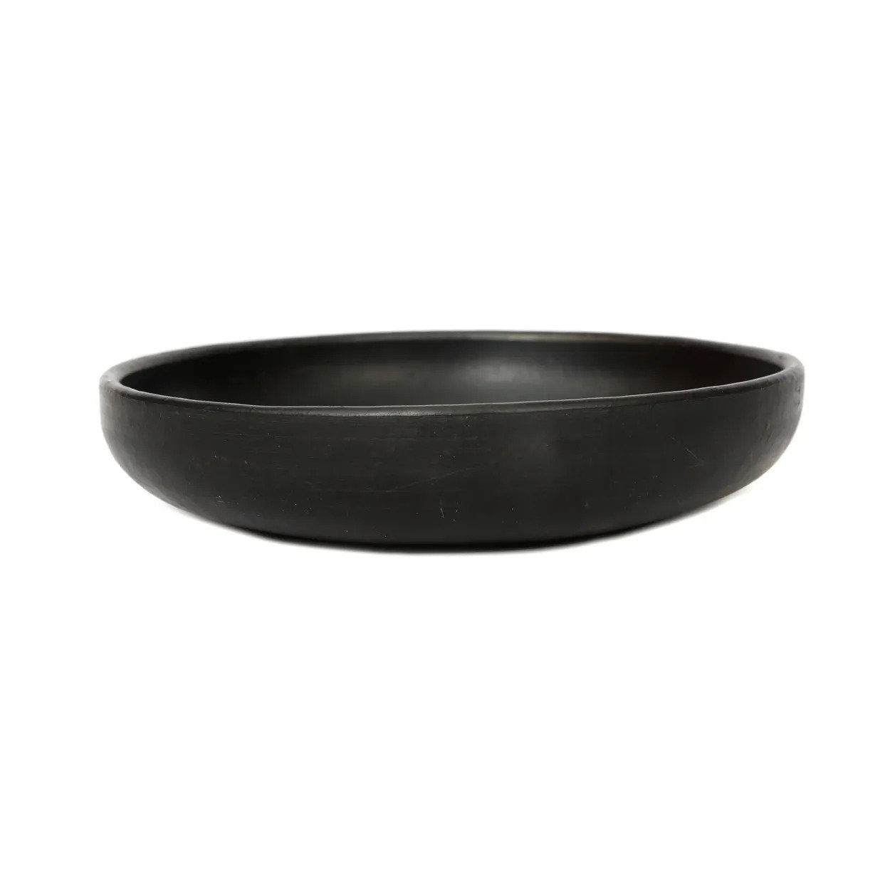 Medium black terracotta plate, artisanal deep dish design for stylish table settings.