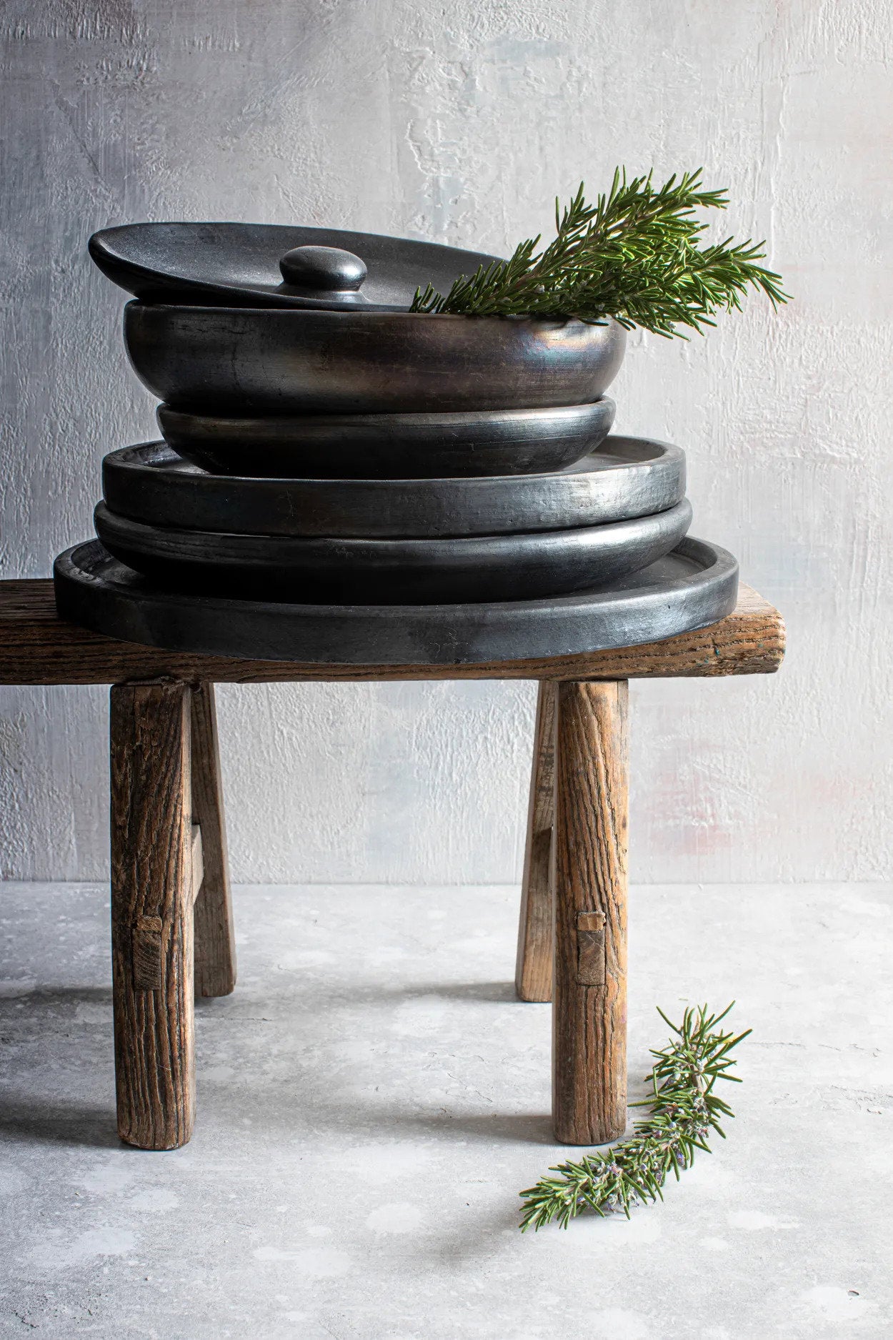 Handmade ceramic dinner plate, deep and versatile, crafted in striking black terracotta.