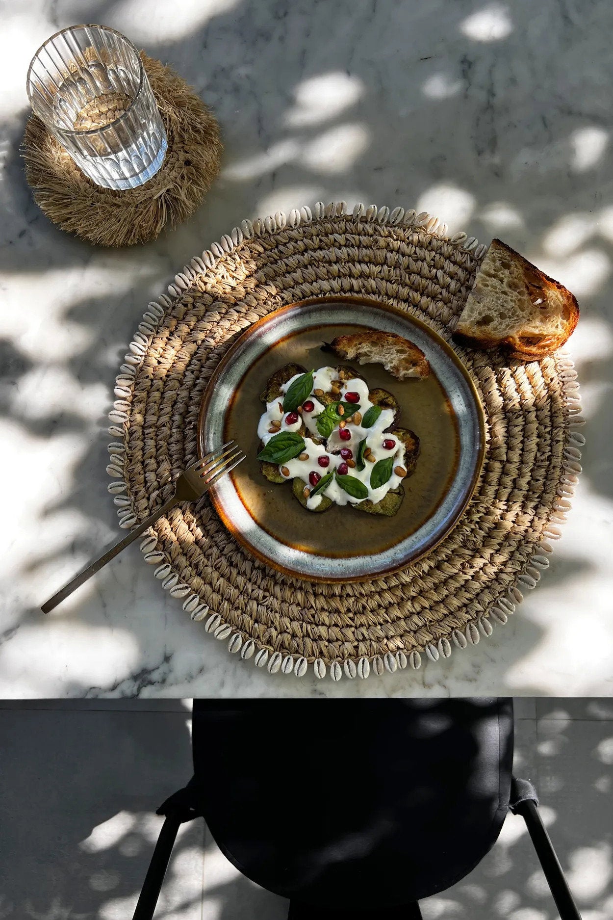 Rustic raffia placemat in natural tones, handcrafted to bring texture, warmth, and elegance to table settings