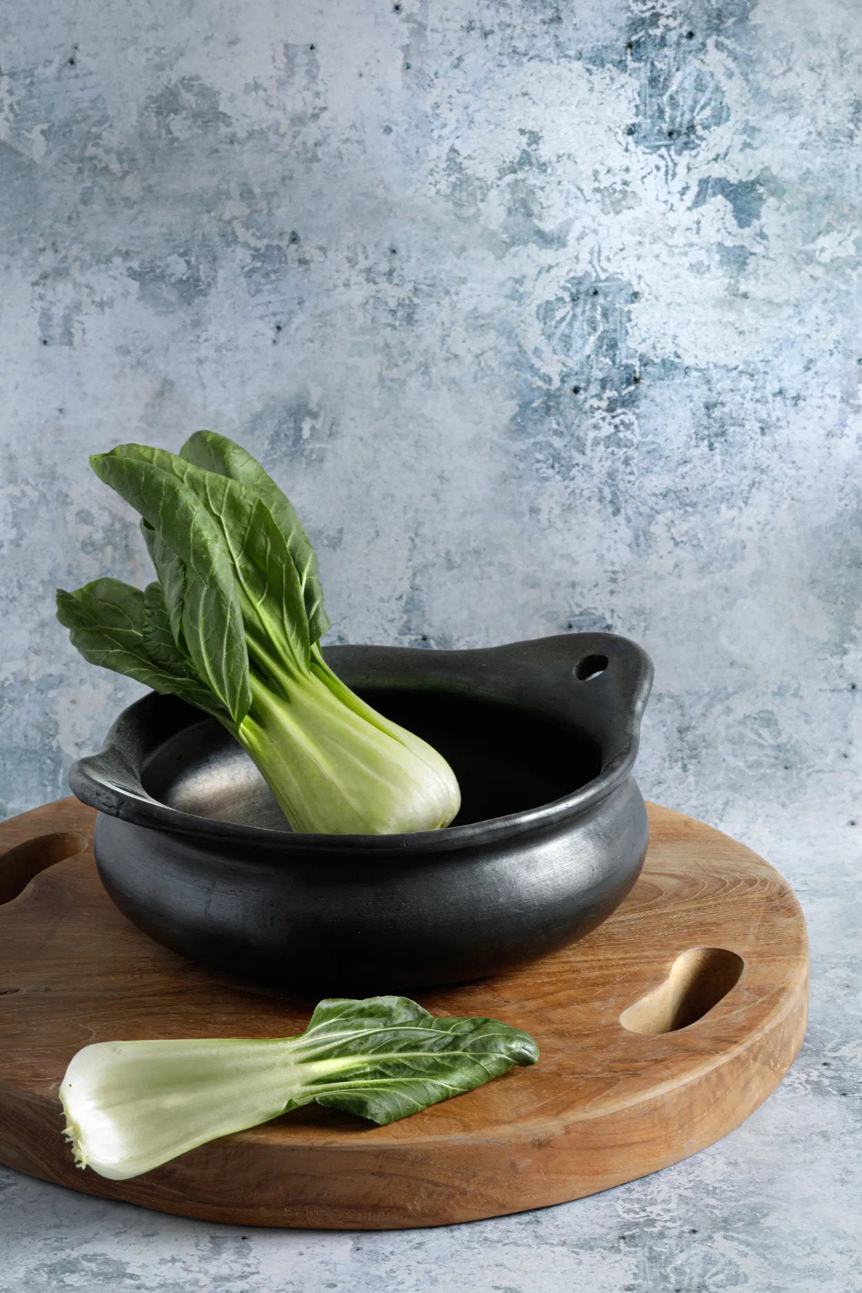 Unique handmade terracotta pot in deep black, perfect for stews, soups, and sauces.