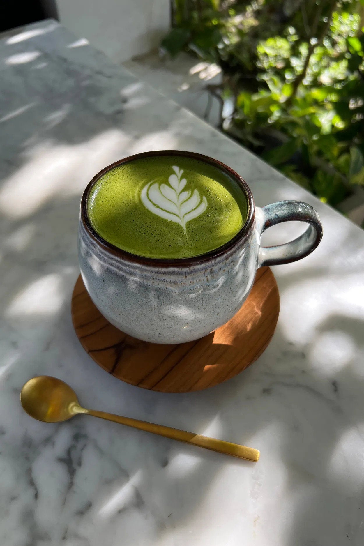 Teak wood coaster with smooth surface, ideal for coffee, tea, or cocktails in a refined setting.