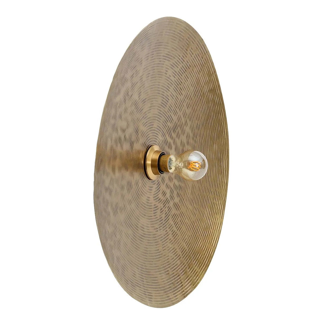Handmade brass wall lamp with eco-friendly materials, casting a warm, inviting glow in a stylish living room setting.