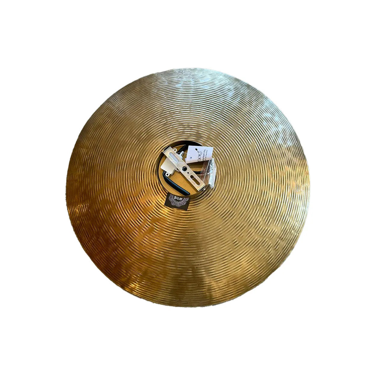 Close-up of the speckled brass surface on The Full Moon Wall Lamp, emphasizing its artisanal quality and unique patterning.