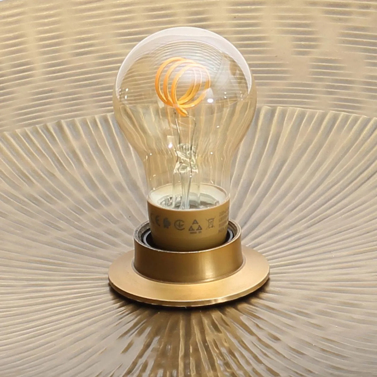 The Double Full Moon Wall Lamp in brass, showcasing its layered, stacked disc design that creates depth and sophistication on your wall.