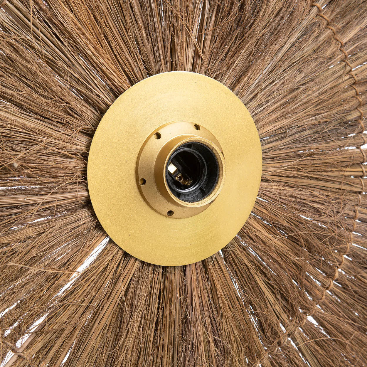 Rustic-meets-modern brass wall lamp shown in a hallway, adding texture, elegance, and functional lighting to transitional spaces.