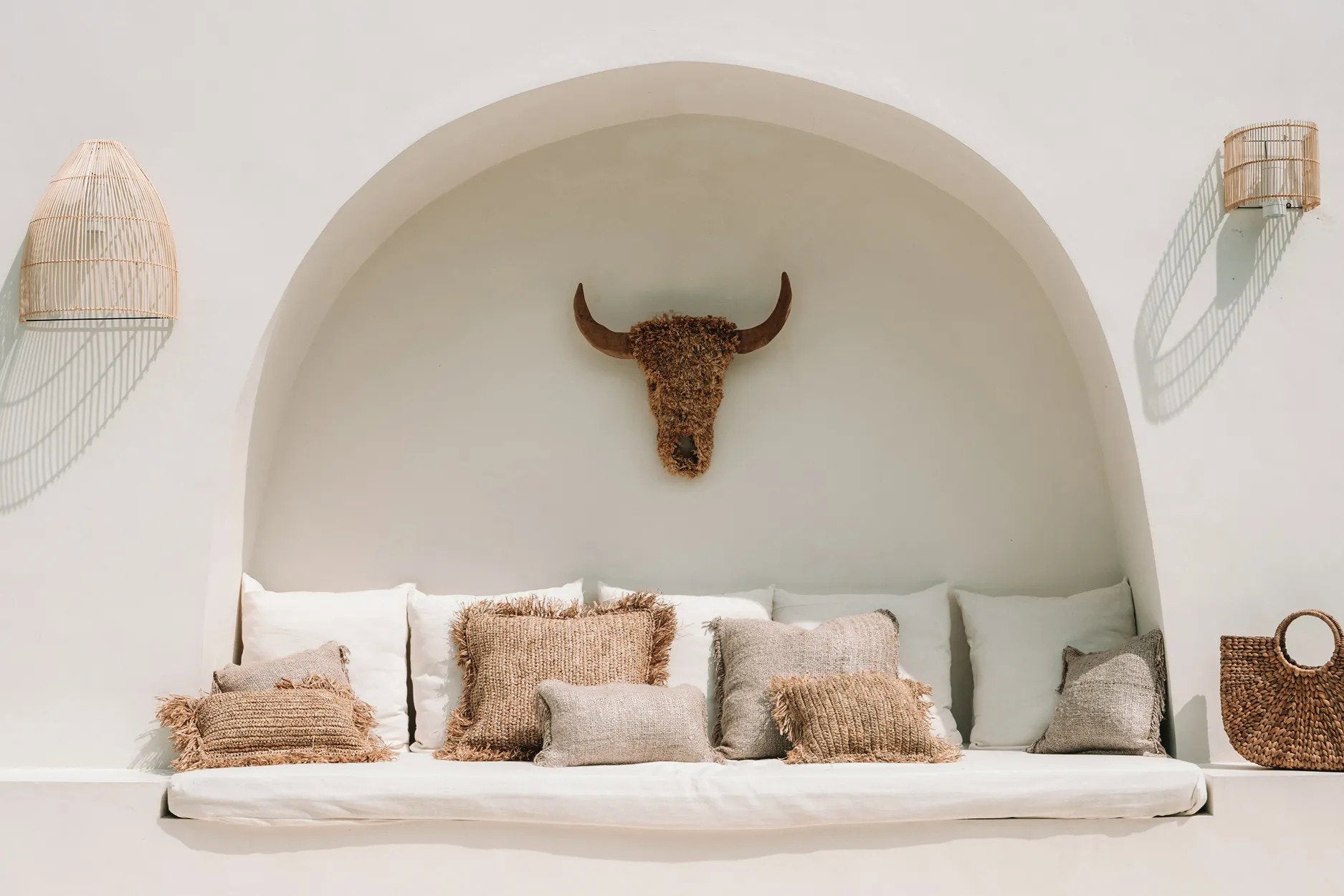 Lightweight, handmade rattan wall light mounted in a bohemian interior, paired with earthy tones and woven decor.