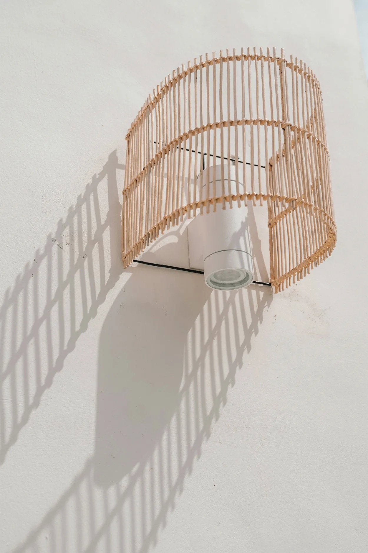 Detail of The Gigi's half-cylindrical shape and open weave, designed to project decorative light patterns on the wall