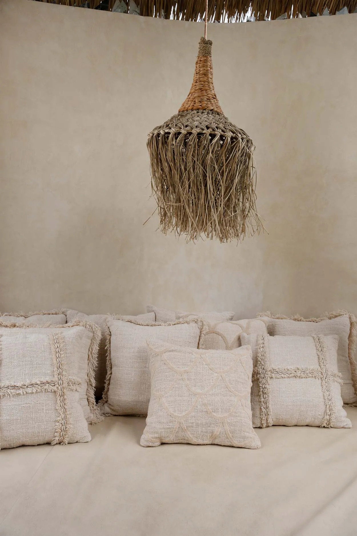 This throw pillow cover features a natural cotton texture and boho design that adds warmth and character to any interior.