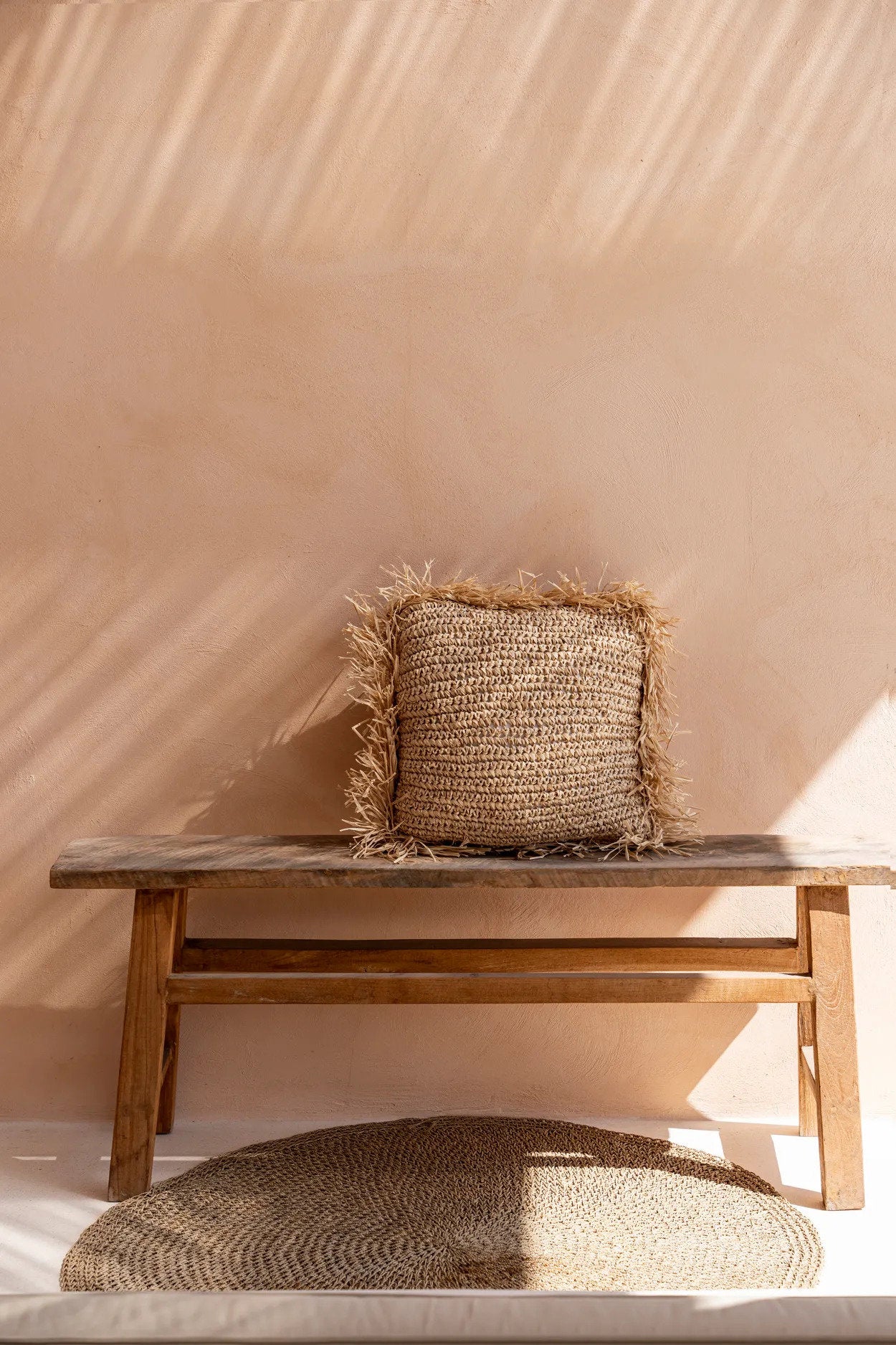 Handwoven square raffia cushion cover in earthy tones for your sofa.
