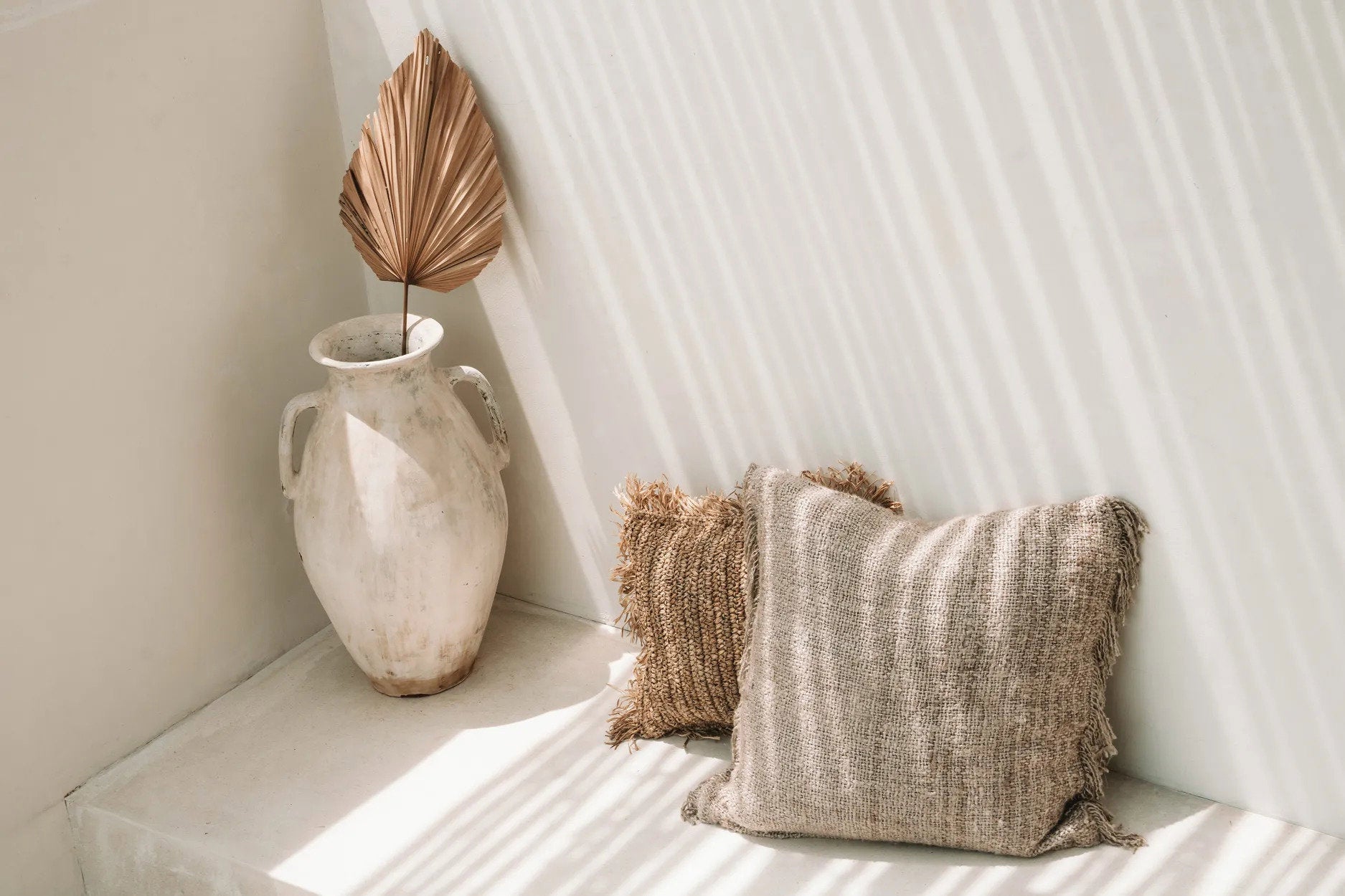 Hand-dyed beige cushion cover with a soft, earthy tone