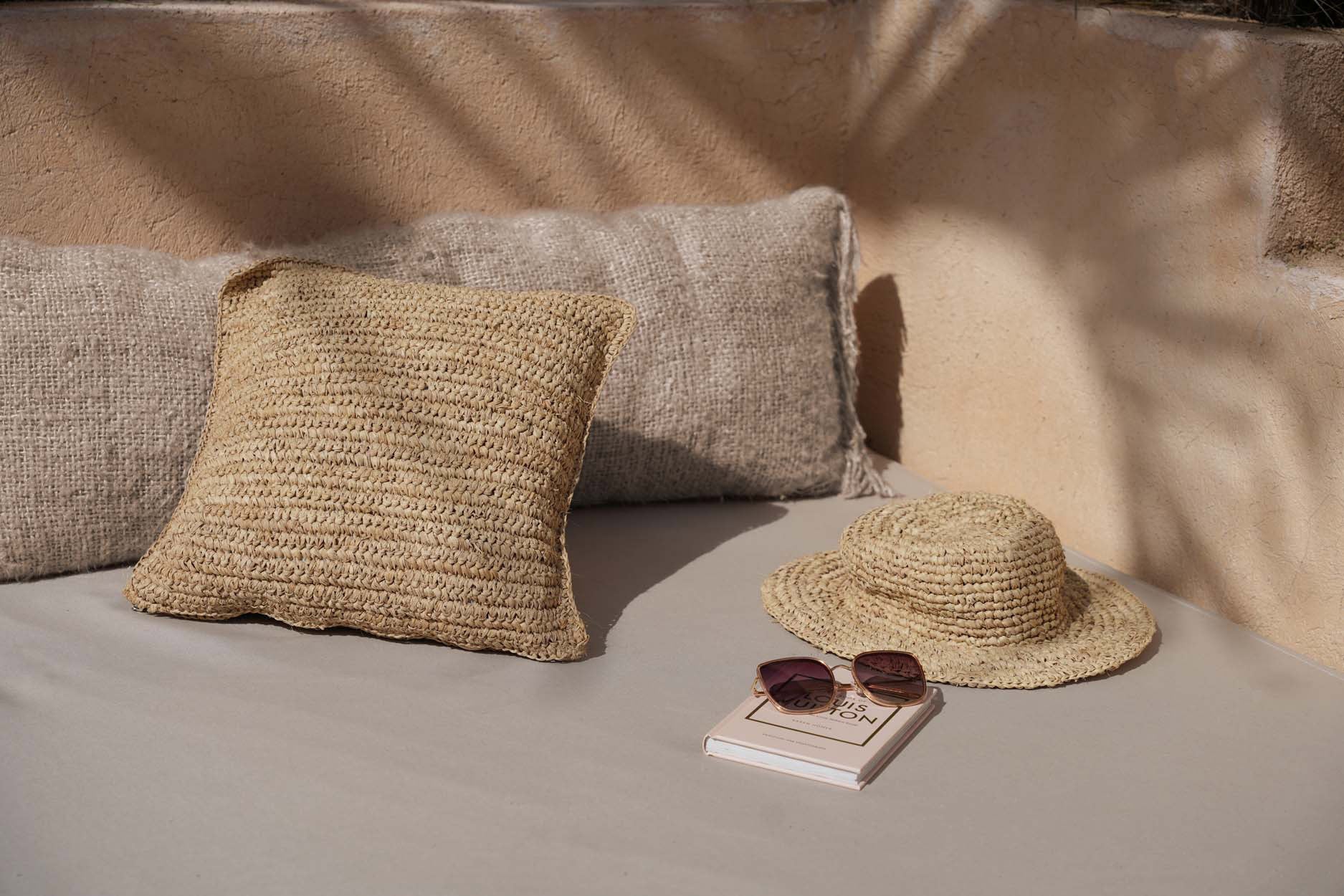 This square raffia pillow cover adds a woven, decorative touch to any boho-inspired living room or cozy reading nook.