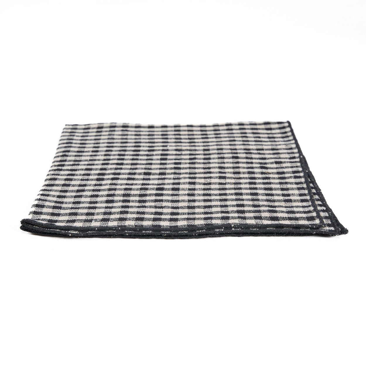 Folded black and white vichy linen napkin, perfect for casual picnics or outdoor meals