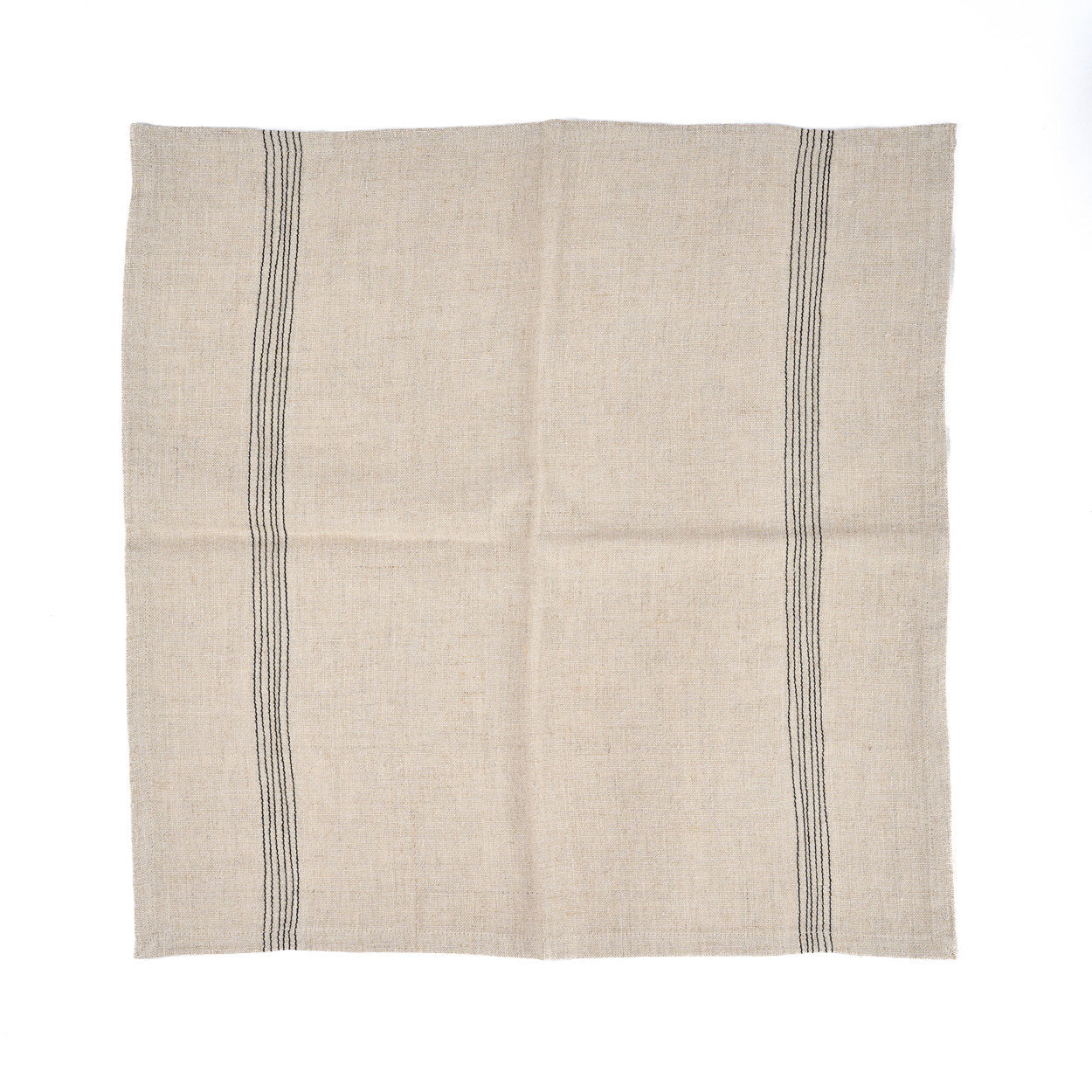 Natural linen napkin with black farmhouse stripes, styled with neutral tableware for a cozy dining atmosphere.